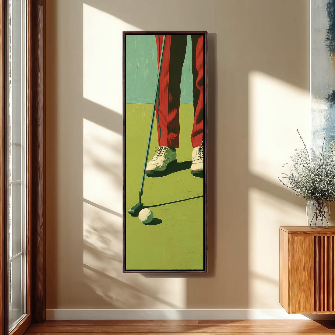 Golfer in red trousers lining up a putt long vertical canvas print in a sunlit living space