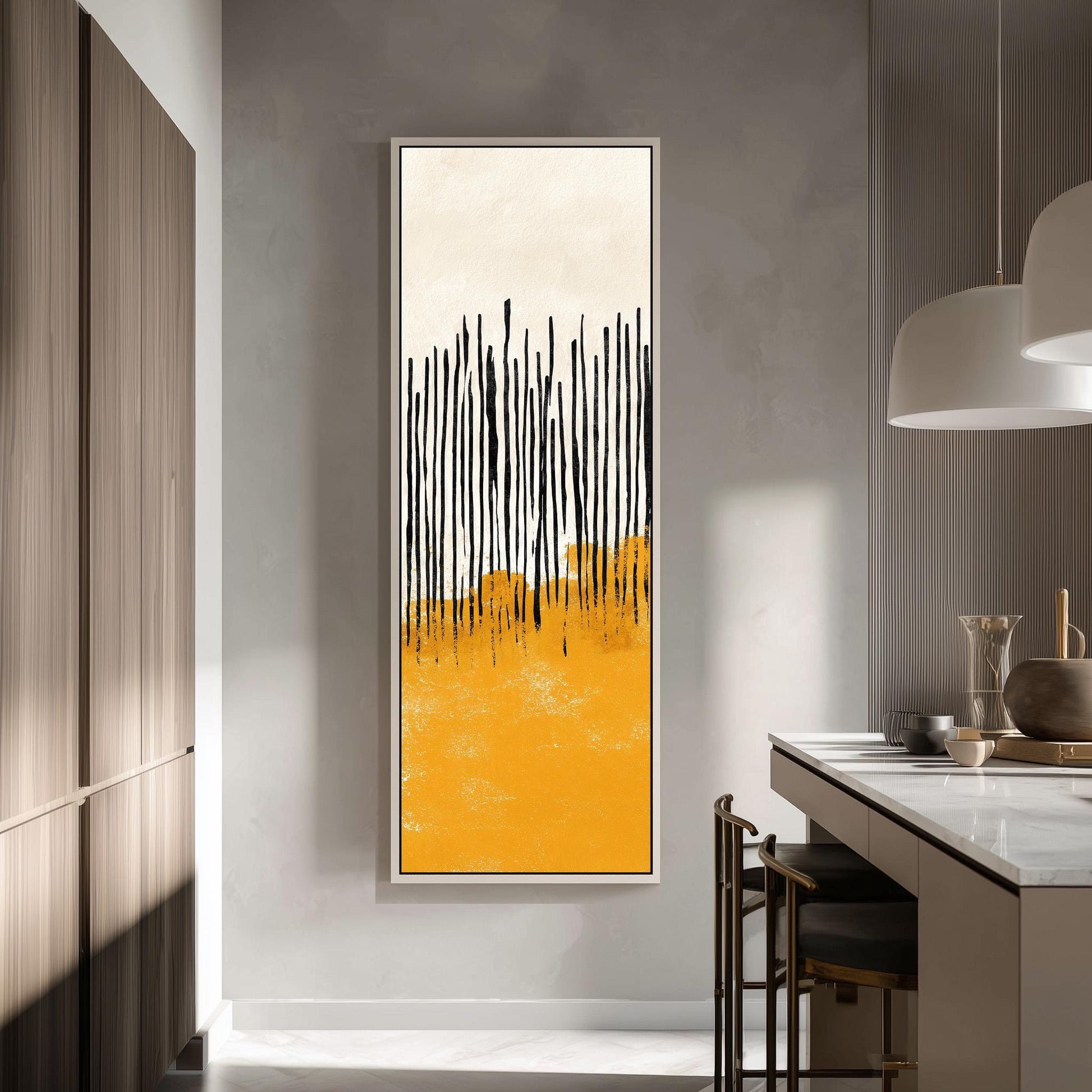 a modern kitchen with a large abstract painting hanging on the wall. The painting has a striking yellow and black color scheme, with vertical lines creating a sense of movement and energy. The kitchen is well-lit, with a pendant light hanging above the countertop and a wooden cabinet visible in the background.
