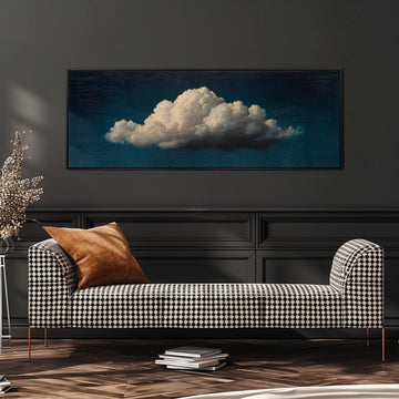 a black and white checkered sofa with a brown throw pillow, set against a dark wall with a large framed painting of a cloud above it.