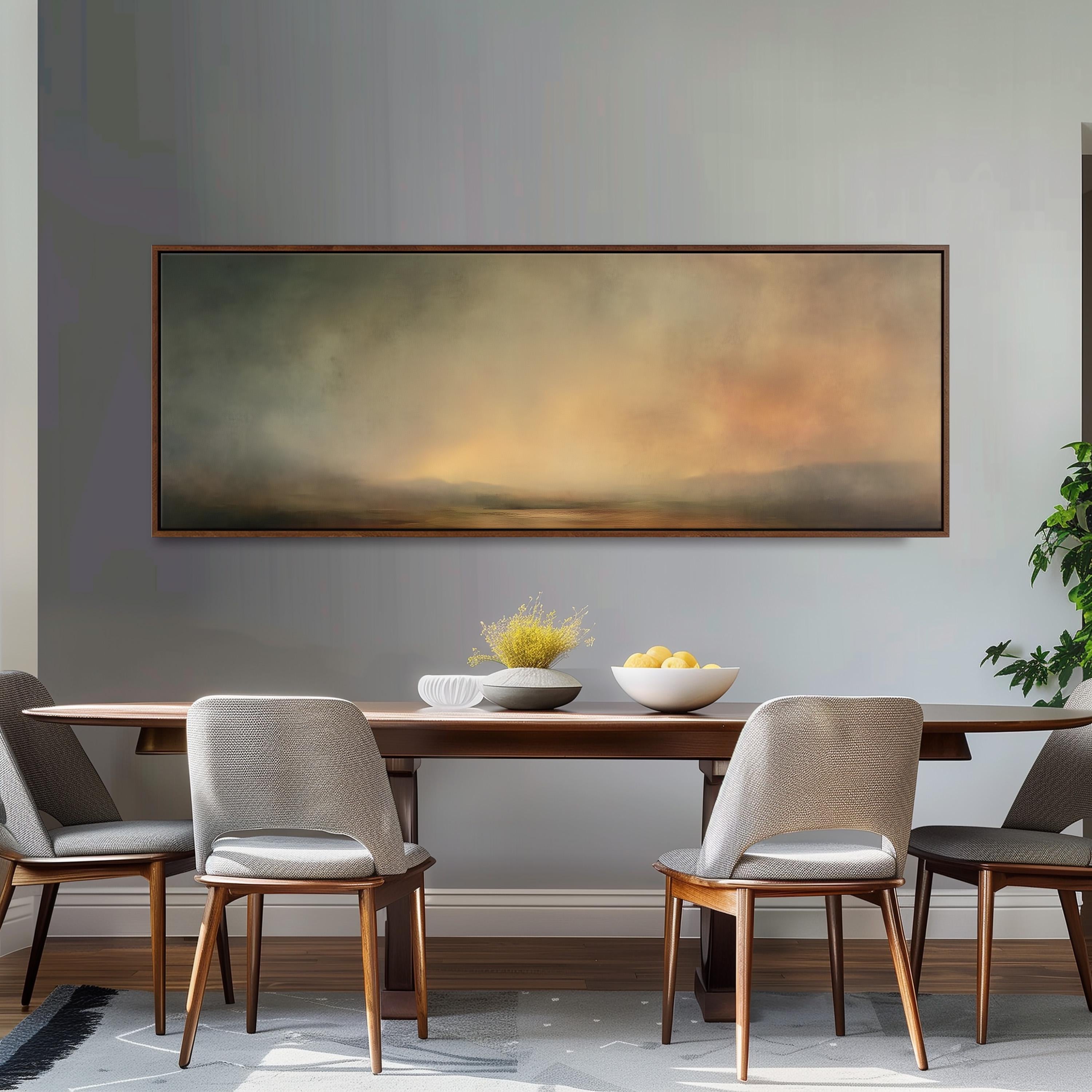 a dining room with a large painting hanging on the wall above a wooden table with four chairs. The painting depicts a landscape scene with a hazy, atmospheric background.