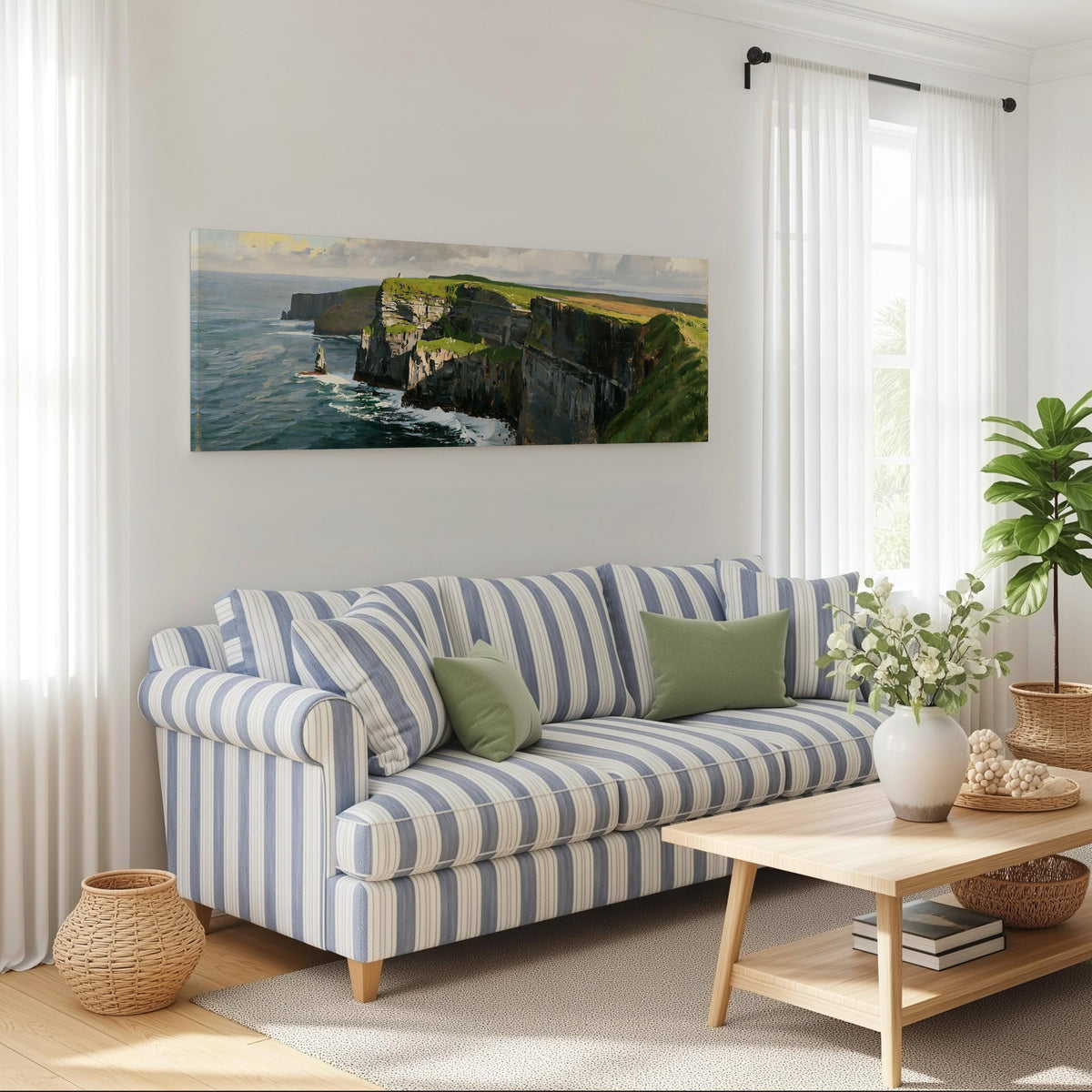 Sunlit sea cliffs with a sea stack long horizontal canvas print above a striped sofa in a coastal living room