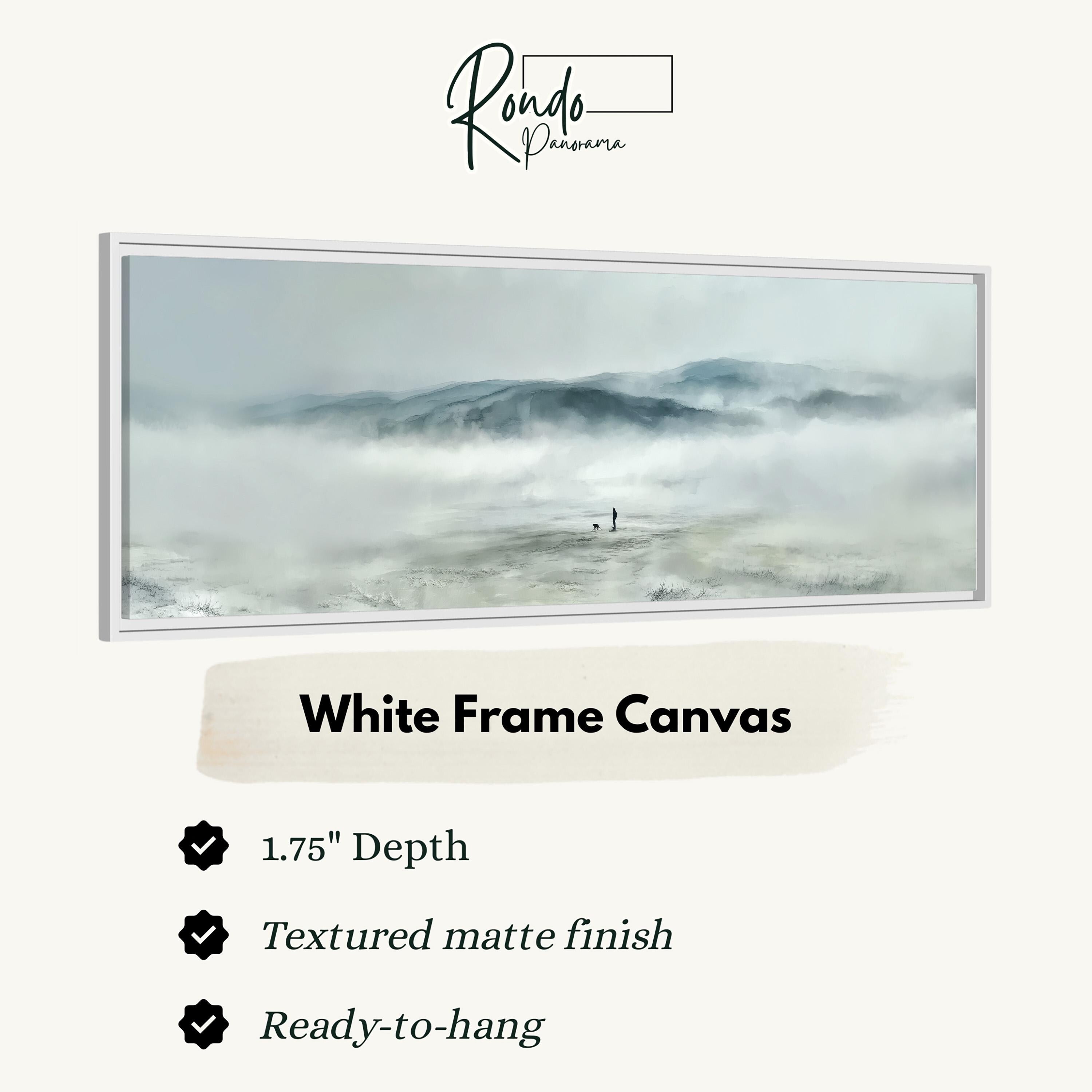 The image is a white frame canvas depicting a landscape with a person standing in the distance, surrounded by fog and mountains.