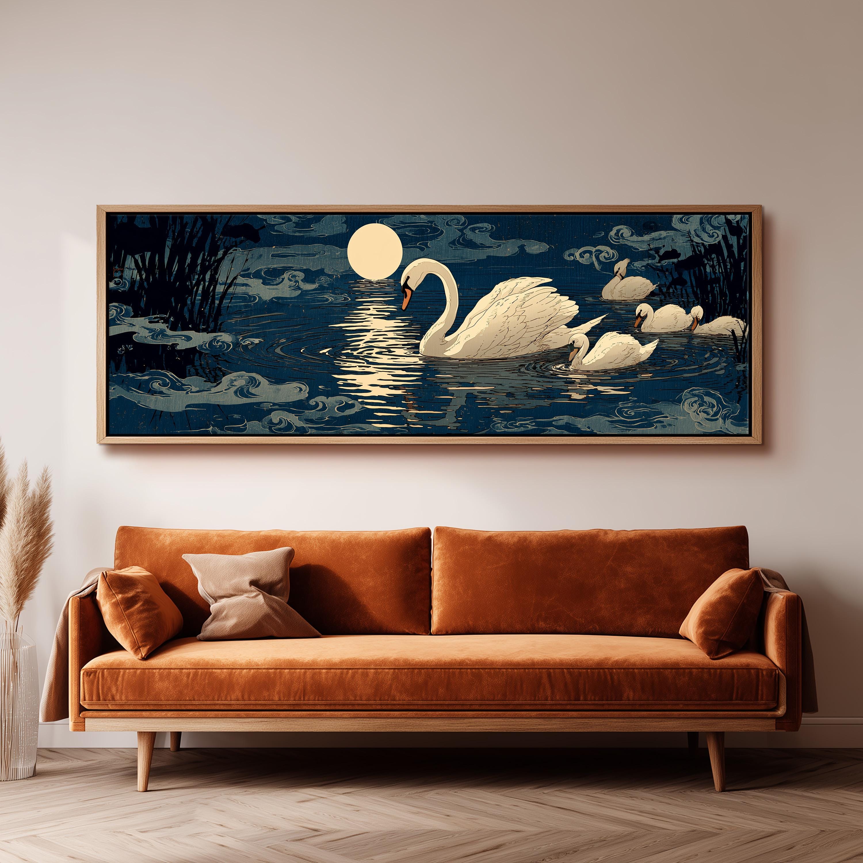 a large painting of a swan swimming on a lake at night, with a full moon in the background. The swan is surrounded by a dark blue lake and the moon is reflected on the water's surface. The painting is hanging on a wall above a brown sofa, creating a serene and peaceful atmosphere in the room.