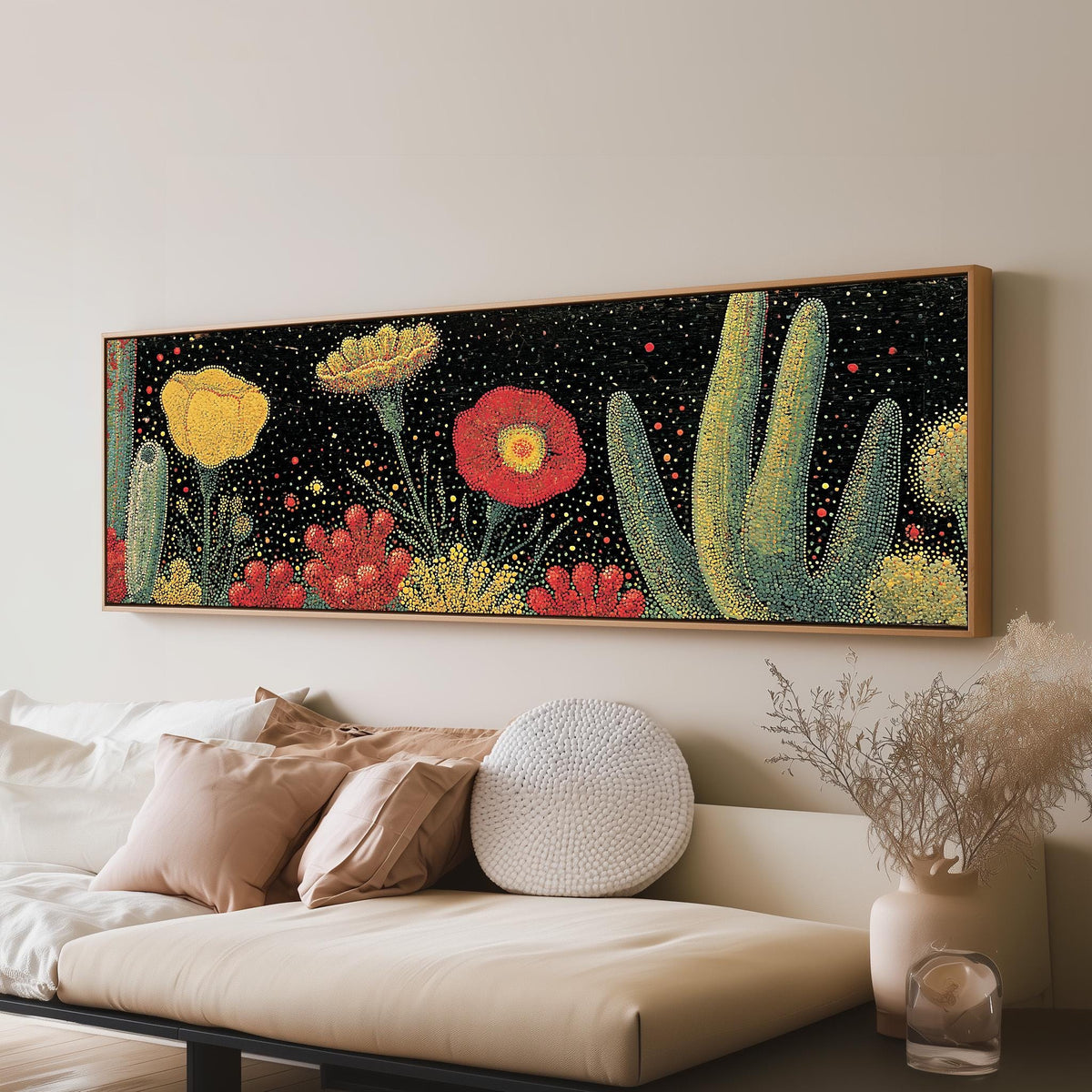Desert blooms and cacti on black panoramic canvas print above a sofa in a living room