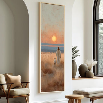 a serene indoor setting with a large painting of a person in a long white robe standing in a field, gazing out at the sunset. The painting is framed and hangs on a white wall, with a window and a chair visible in the background.