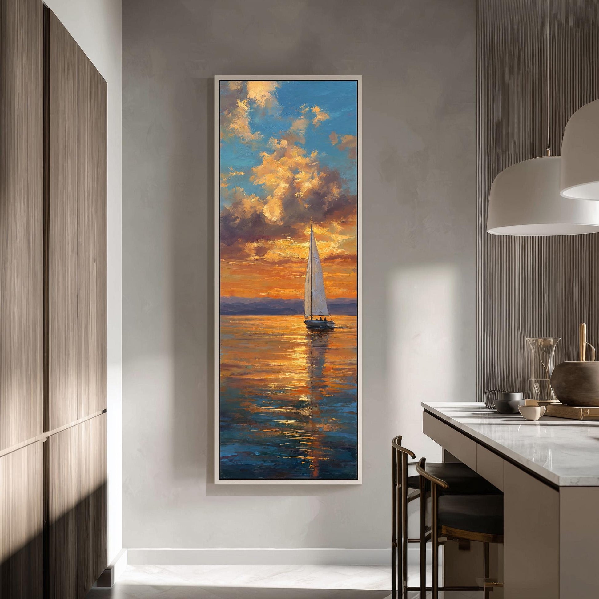 a large painting of a sailboat on the water, with a vibrant sunset in the background. The painting is hung on a wall in a room with a kitchen counter and chairs nearby.