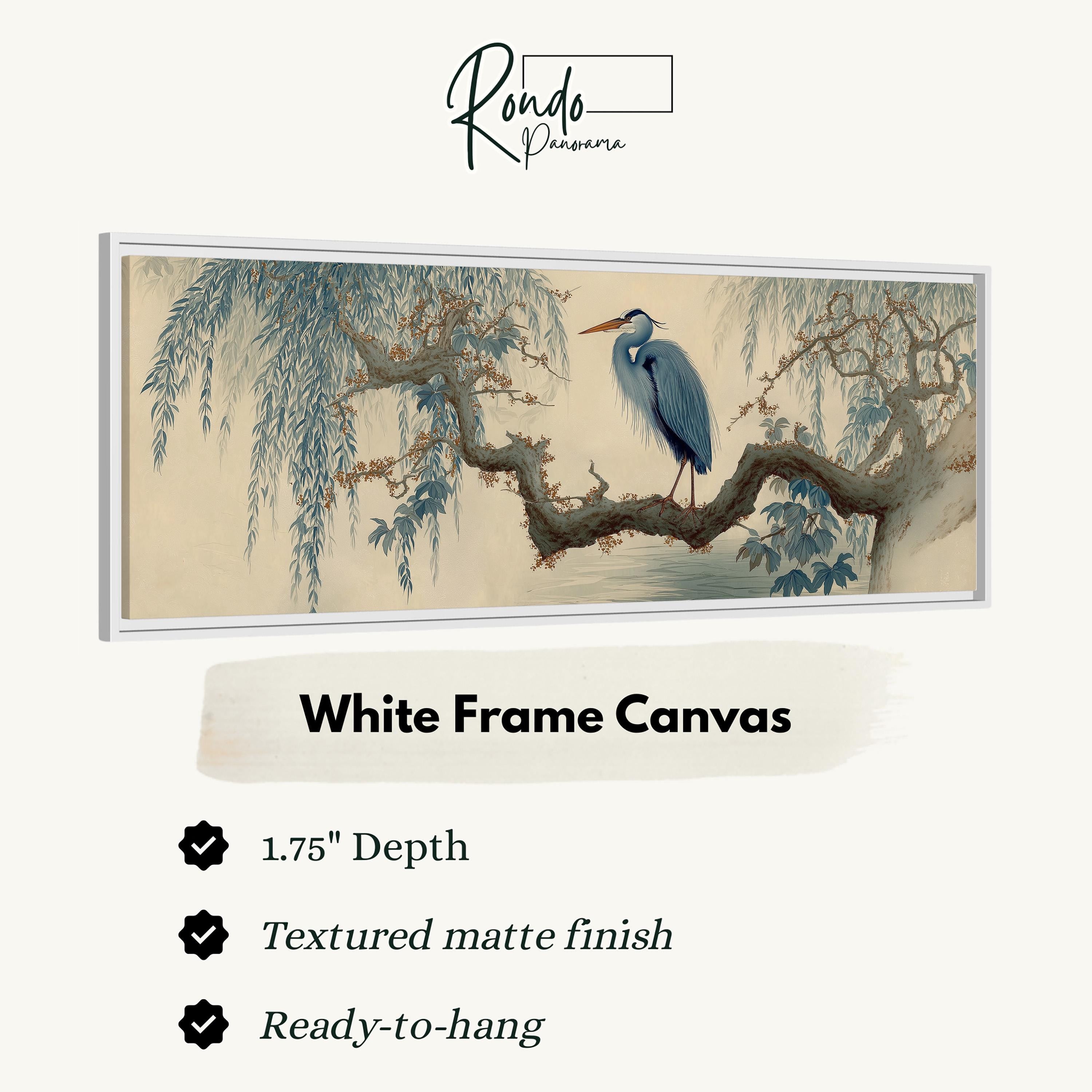 The image is a framed artwork depicting a blue heron perched on a branch with a textured finish. The artwork is described as a "White Frame Canvas" with a depth of 1.75" and a textured matte finish. It is ready to hang.