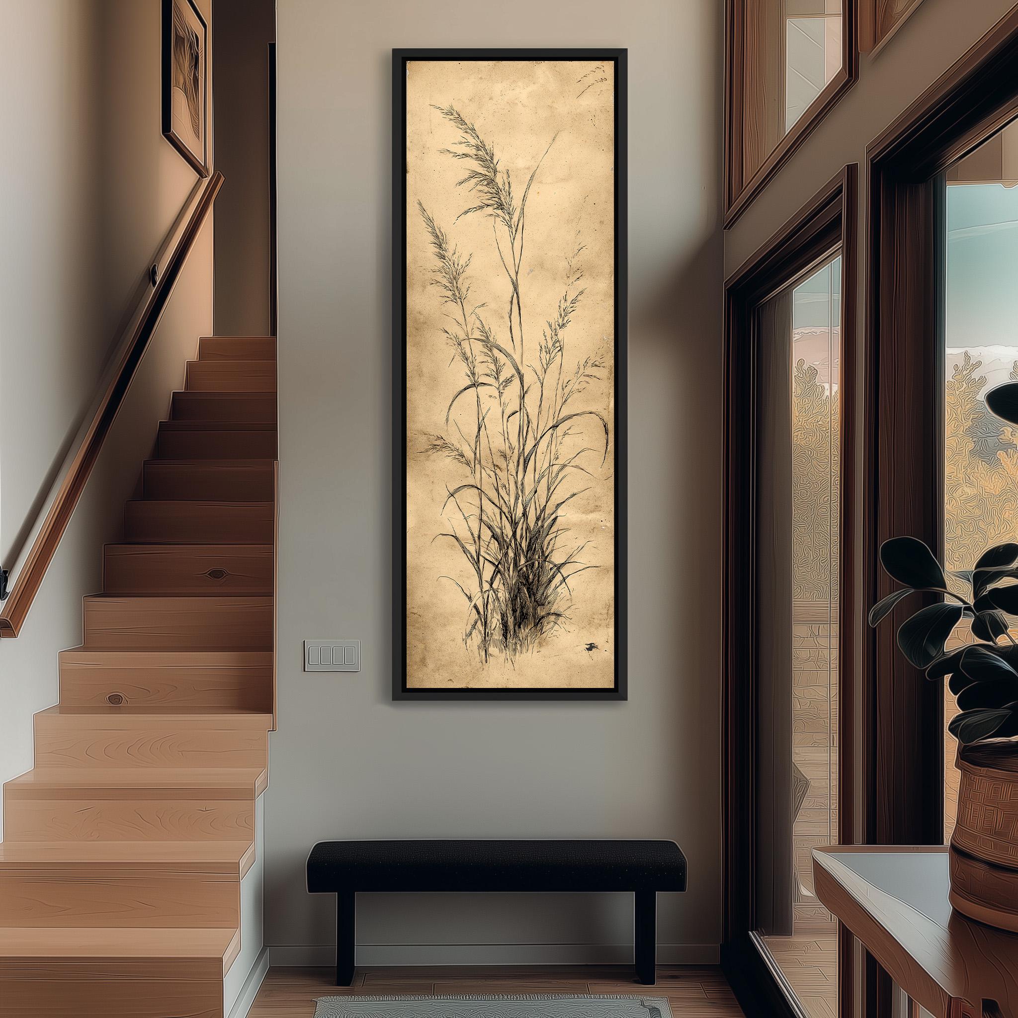 a hallway with a wooden staircase, a large framed artwork depicting tall grasses hanging on the wall, and a black bench in the foreground.
