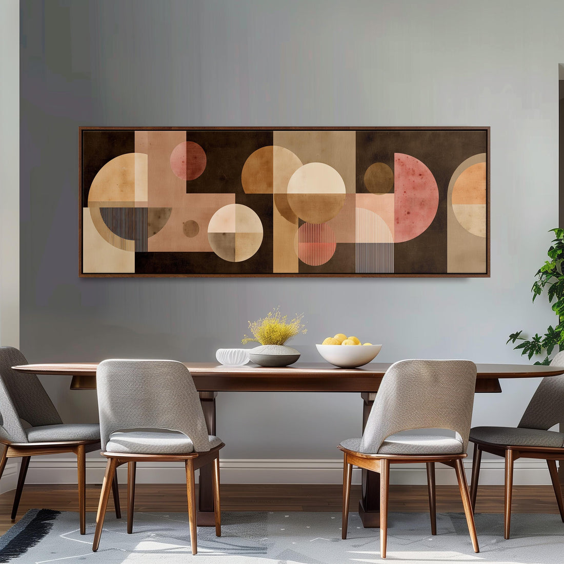 a large abstract painting hanging on a wall above a brown sofa with two pillows.