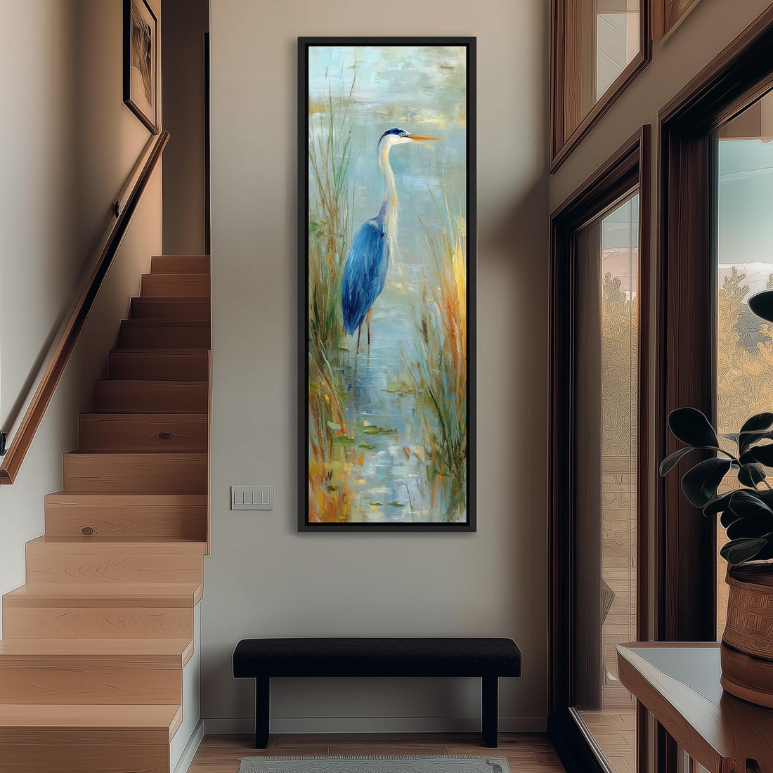 a large painting of a blue heron standing in a pond, surrounded by tall grass and plants. The painting is hung on a wall in a room with a wooden cabinet and a vase of flowers nearby.