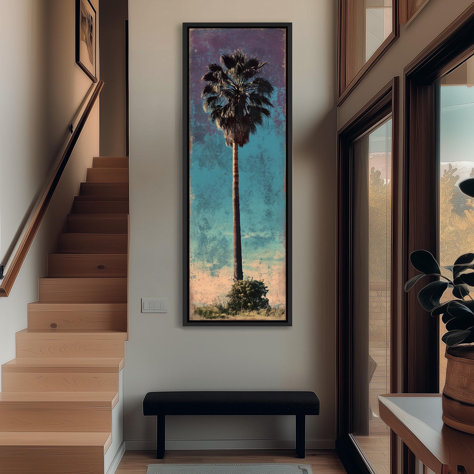 a large framed painting of a palm tree hanging on a wall in a hallway.