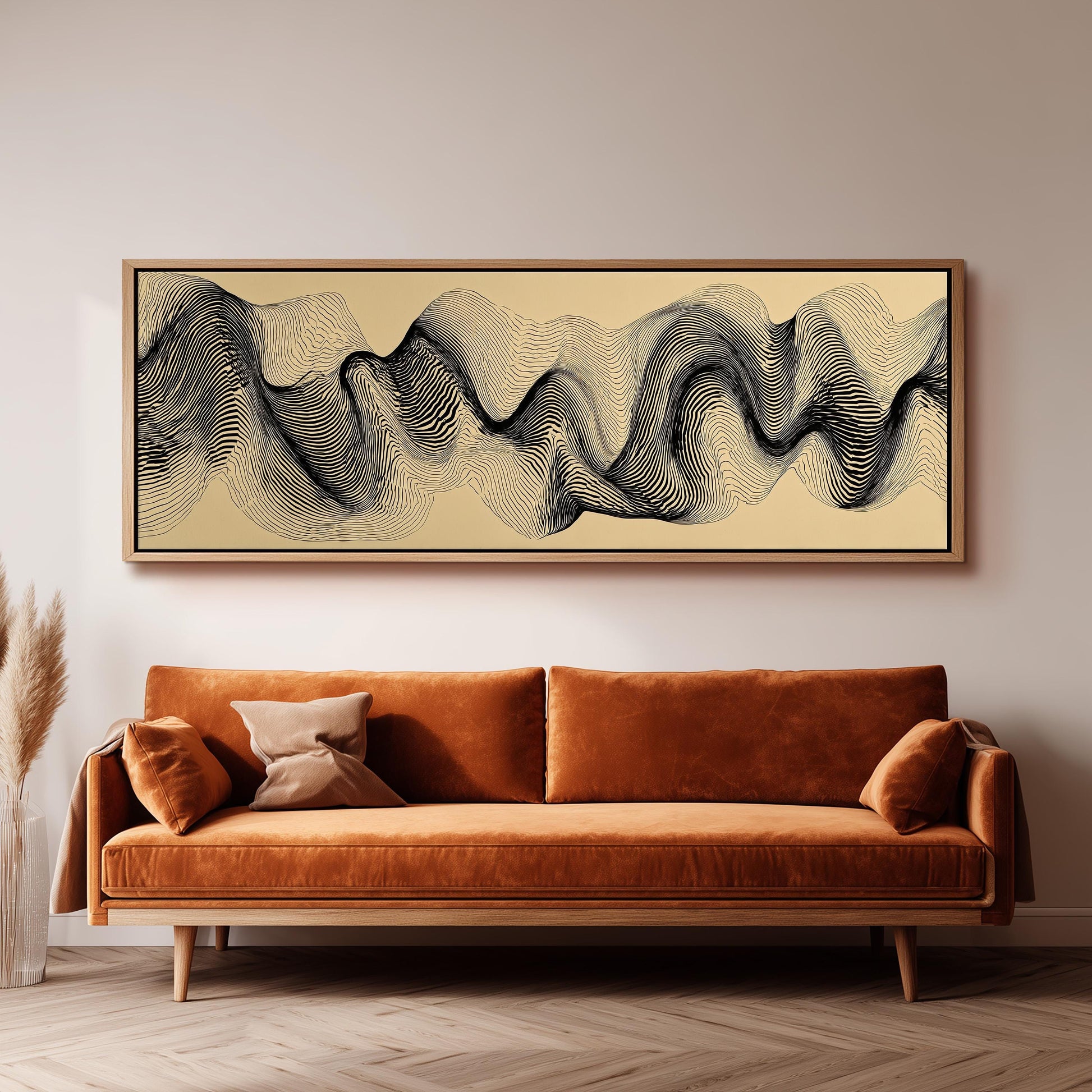 a large abstract painting hanging on a wall above a brown sofa with orange cushions.