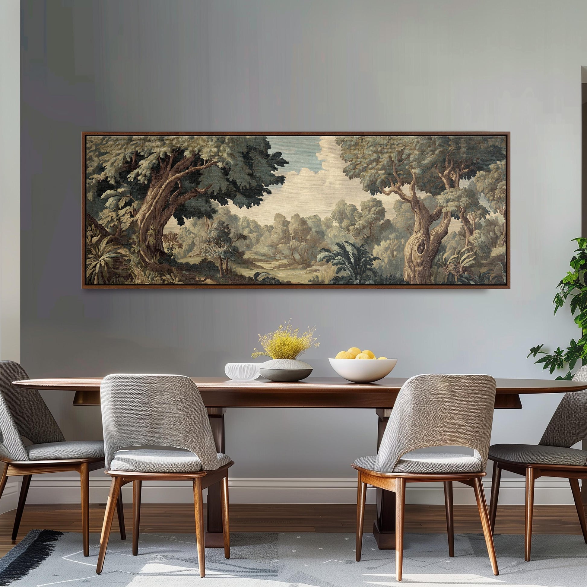 a dining room with a large painting of a forest landscape hanging on the wall above a wooden dining table with four chairs. The table is set with a bowl of fruit and a vase of flowers, creating a cozy and inviting atmosphere.