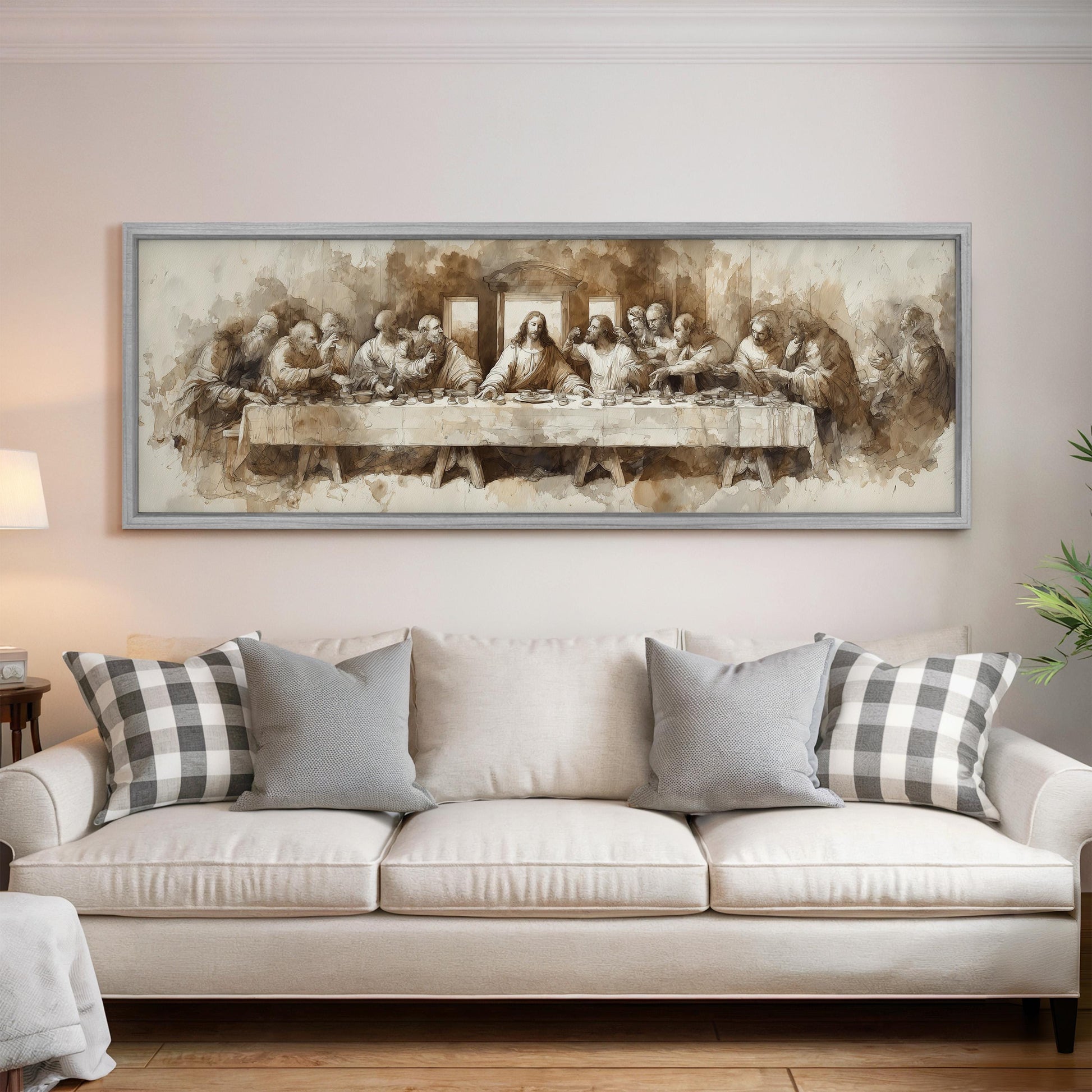 a large painting of the Last Supper hanging on a wall above a white couch with gray and white plaid throw pillows.