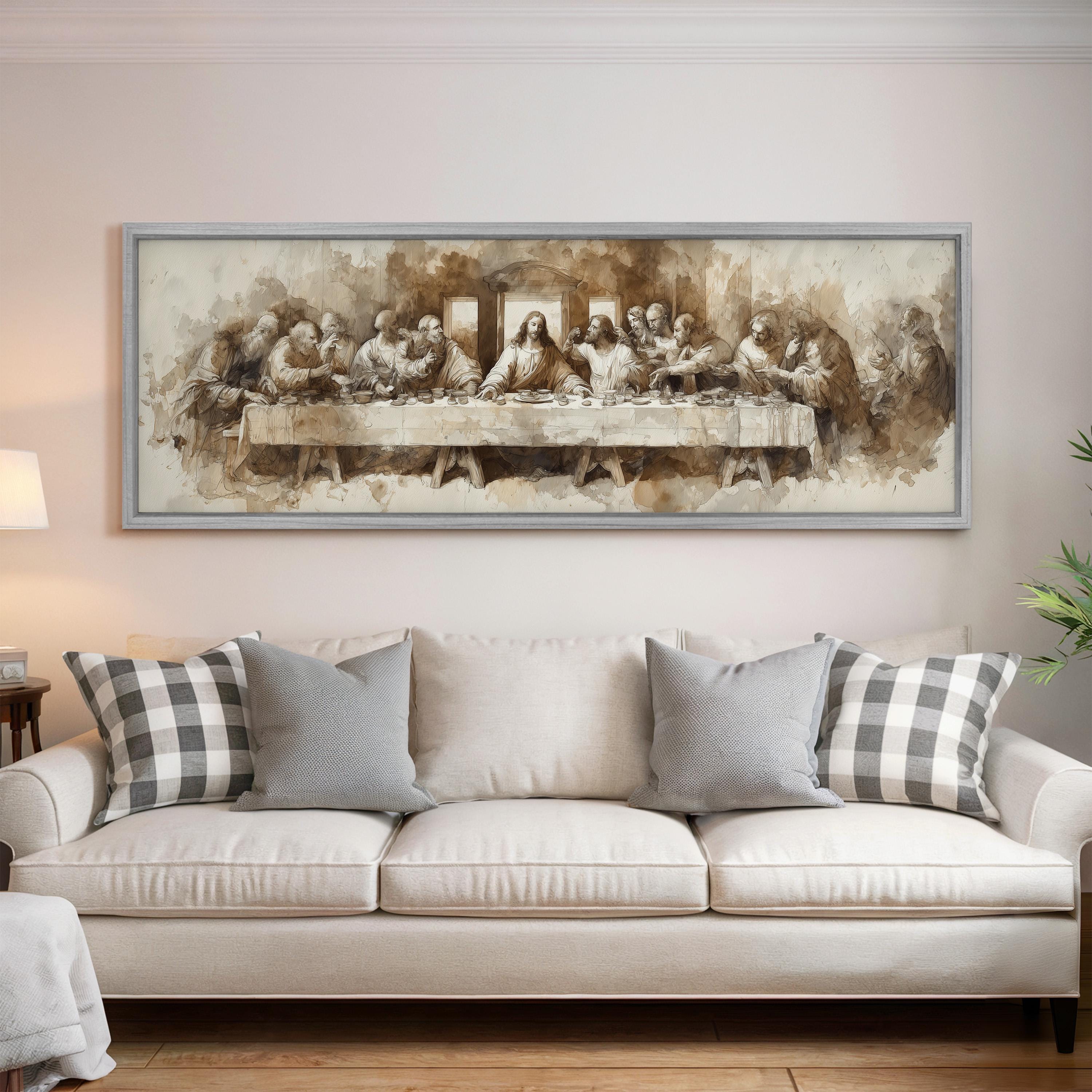 a large painting of the Last Supper hanging on a wall above a white couch with gray and white plaid throw pillows.