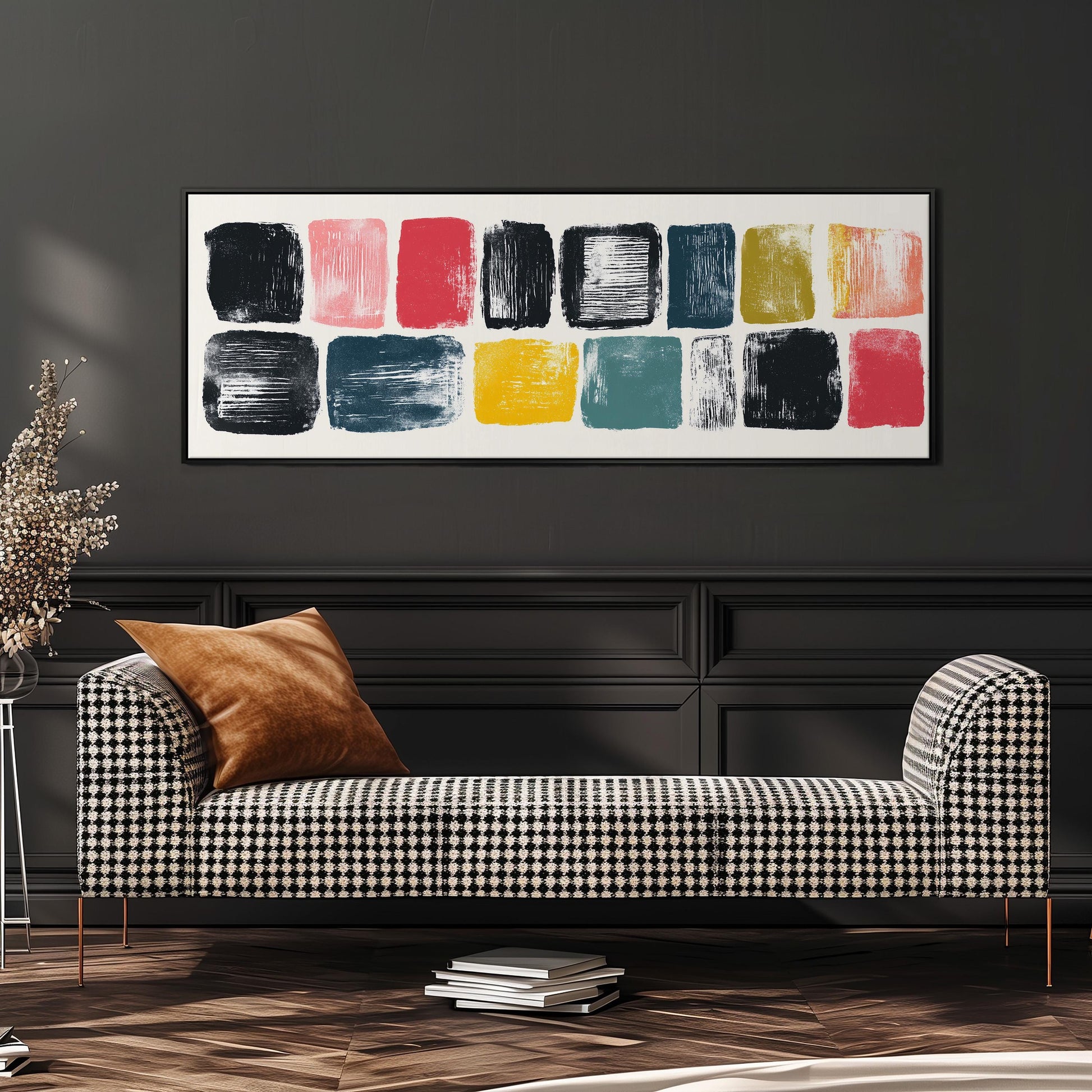 a modern living room with a black and white checkered sofa, a stack of books, and a large abstract painting on the wall.