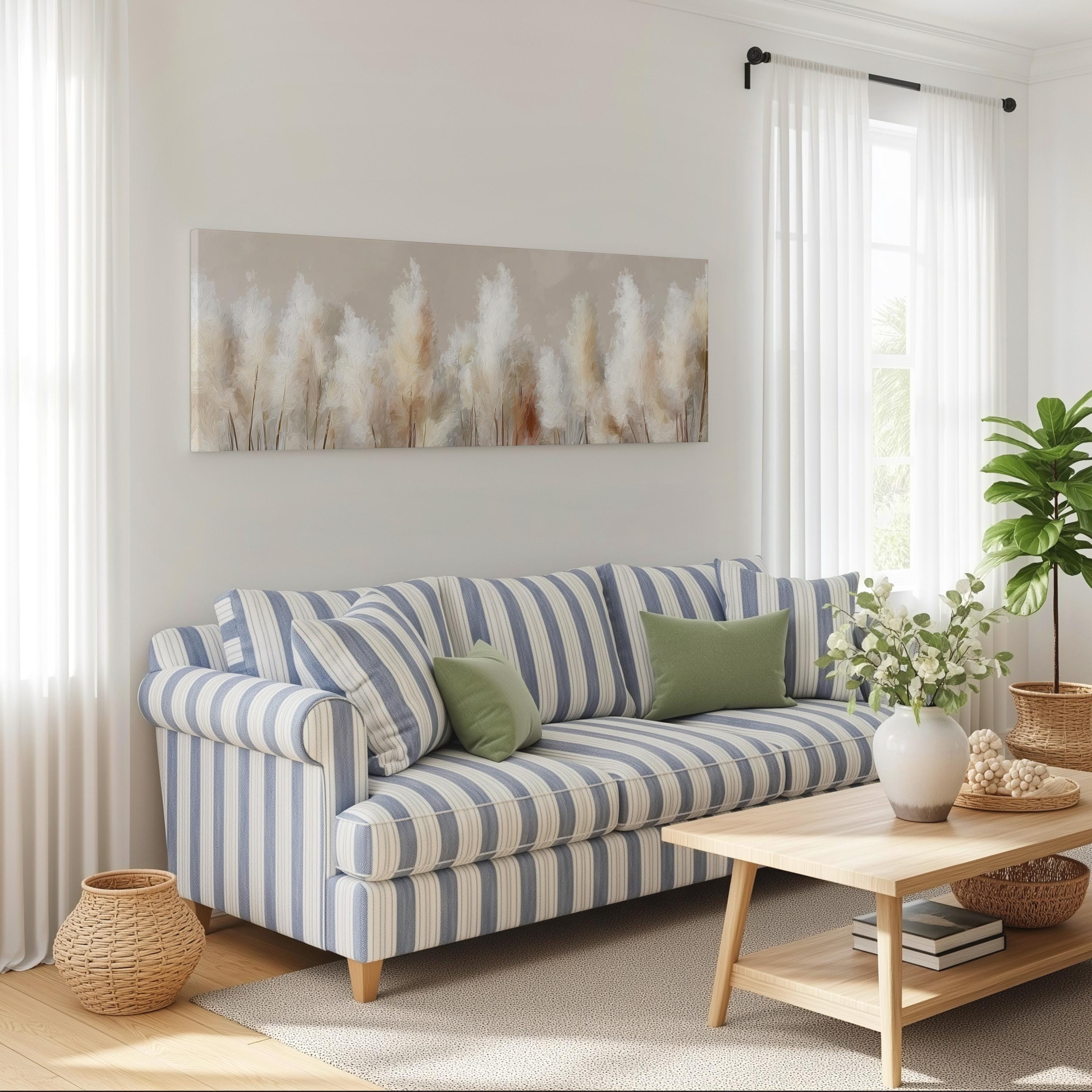a cozy living room with a striped blue and white sofa, a wooden coffee table, and a large window with white curtains. A painting of tall grasses hangs on the wall above the sofa, and a potted plant is placed on the coffee table.