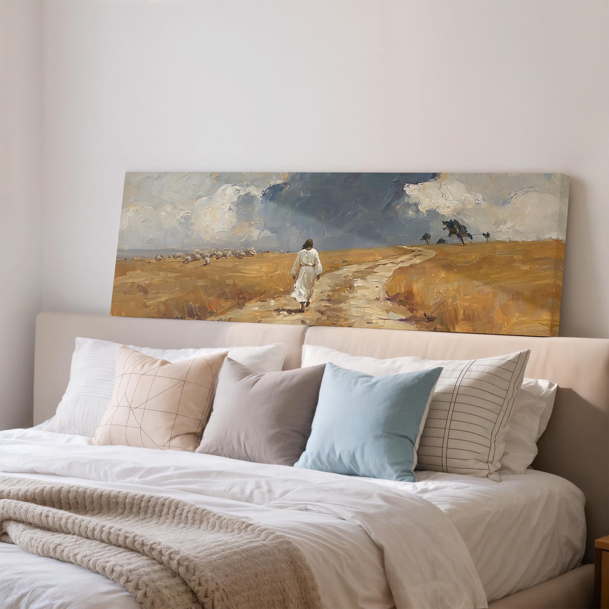 Jesus walking a field path with grazing sheep wide panoramic canvas print above a bed in a bedroom