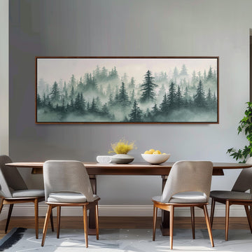 a dining room with a large painting of a forest scene hanging on the wall above a wooden dining table with four chairs. The painting depicts a misty forest landscape with tall trees and a hazy, green color palette.