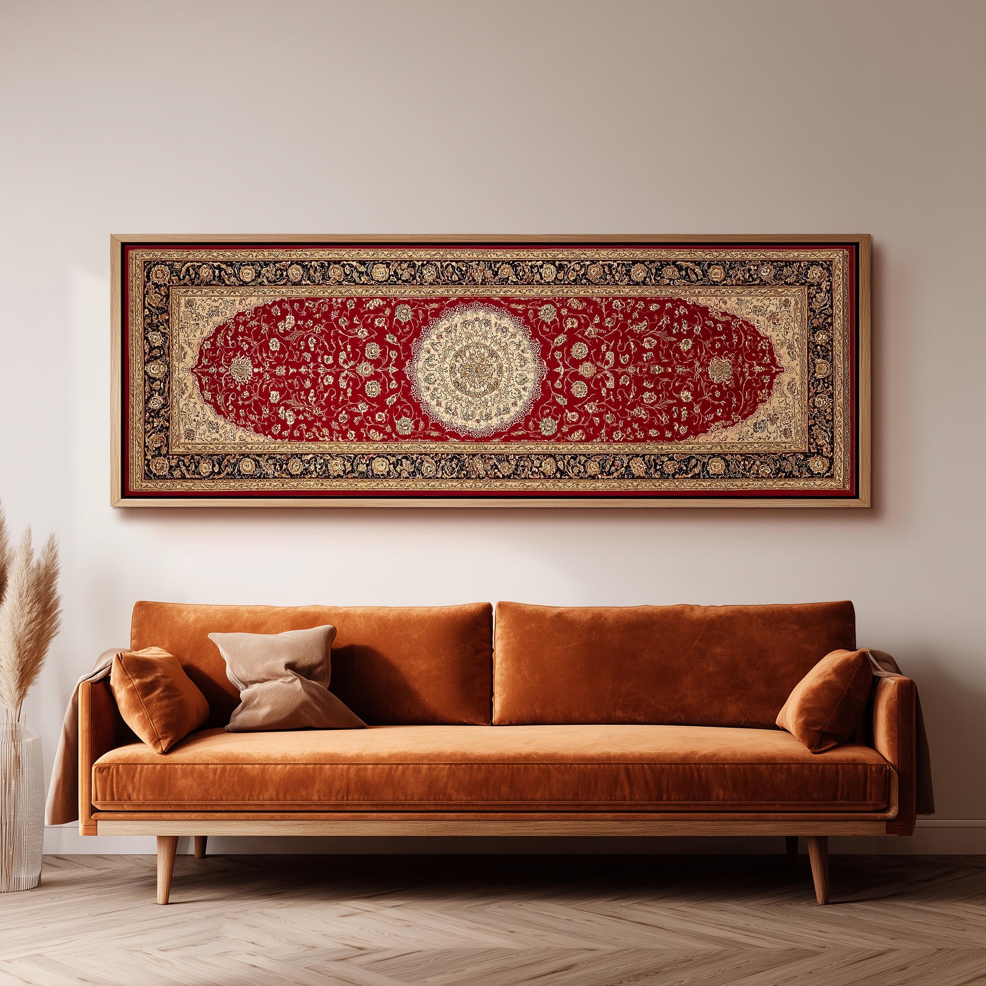 a large, ornate red and gold rug hanging on a white wall above a brown sofa with two pillows.