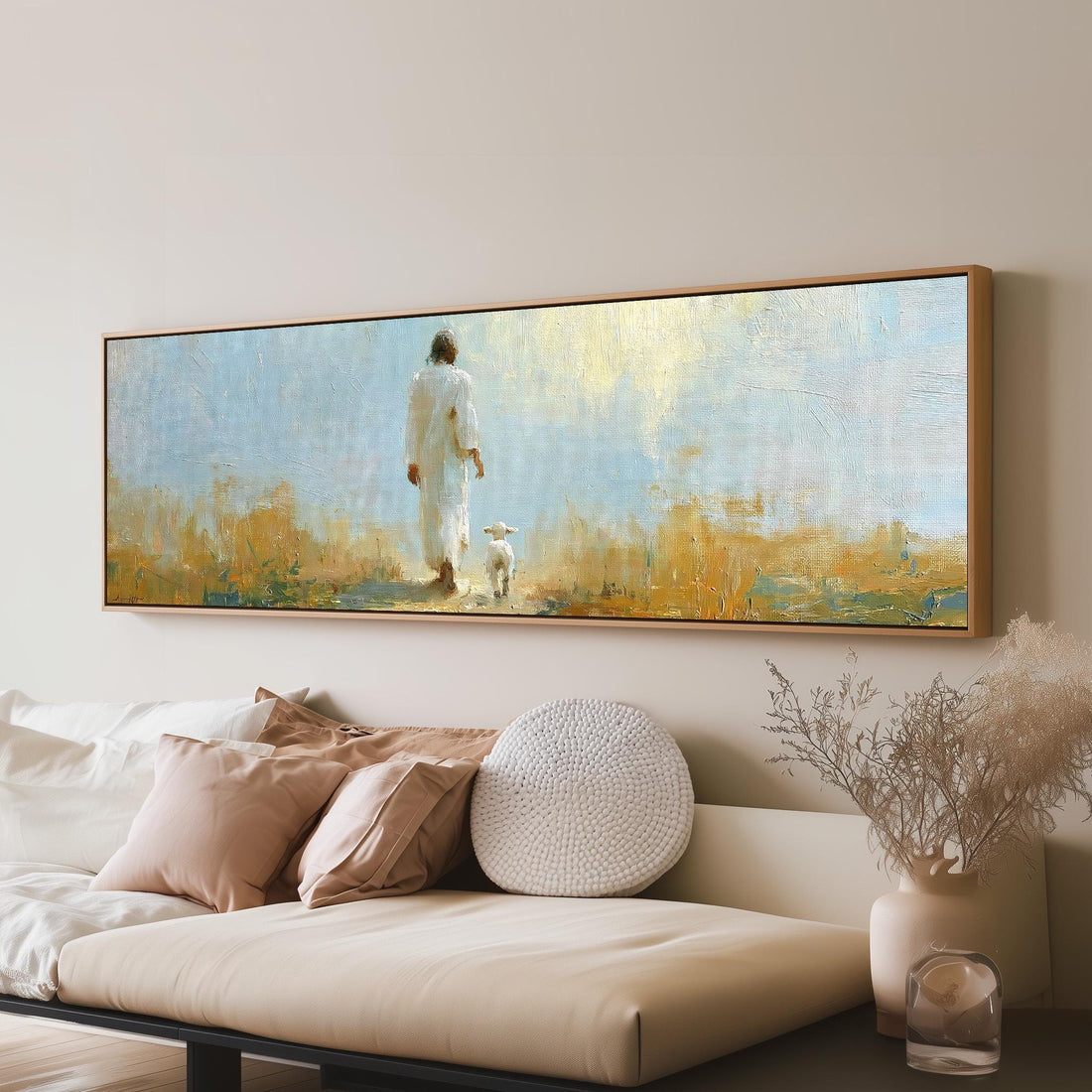 Jesus the shepherd walking with a lamb long horizontal canvas print above a sofa in a living room