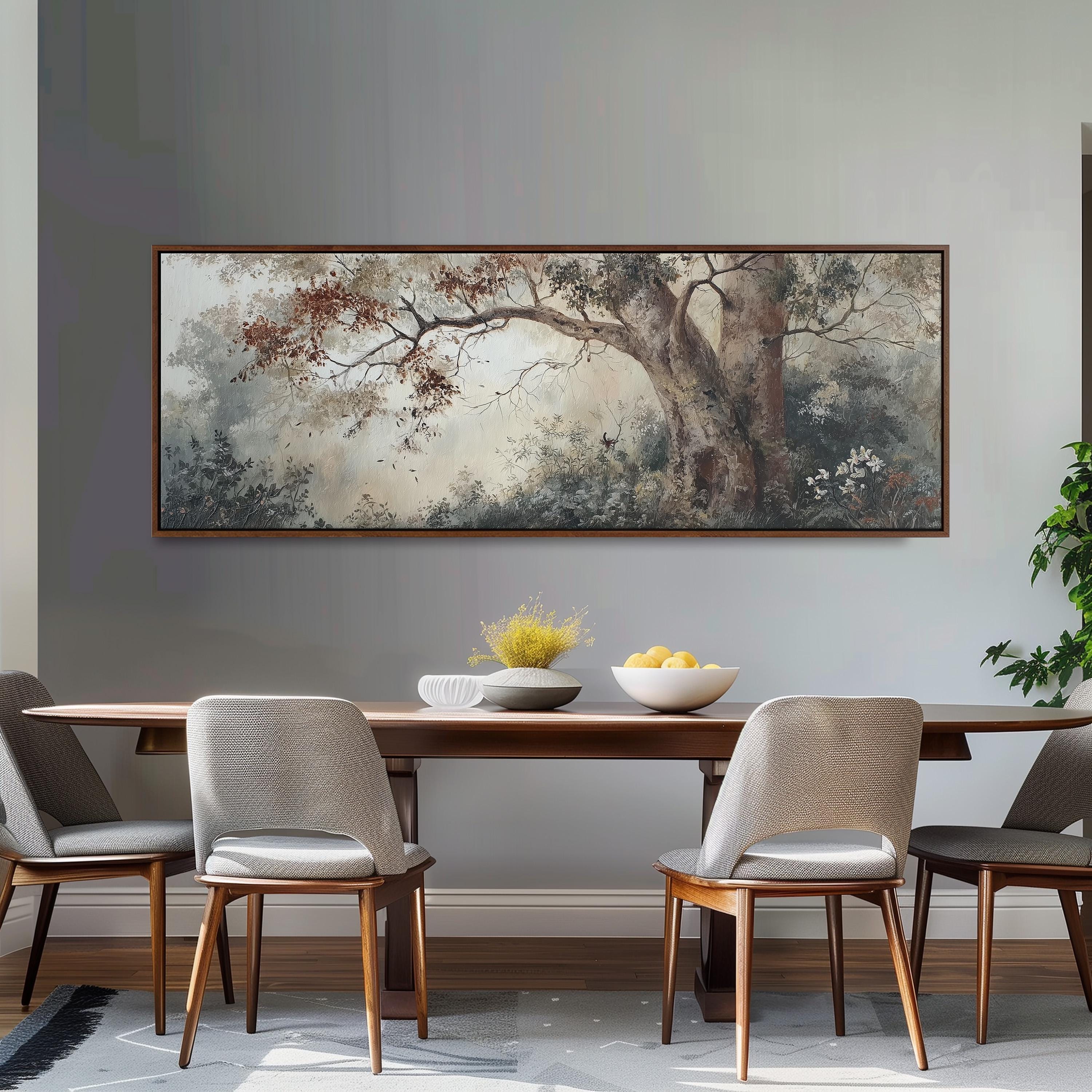 a dining room with a large painting of a tree hanging on the wall above a wooden table with four chairs. The table is set with a bowl of fruit and a vase of flowers, creating a cozy and inviting atmosphere.