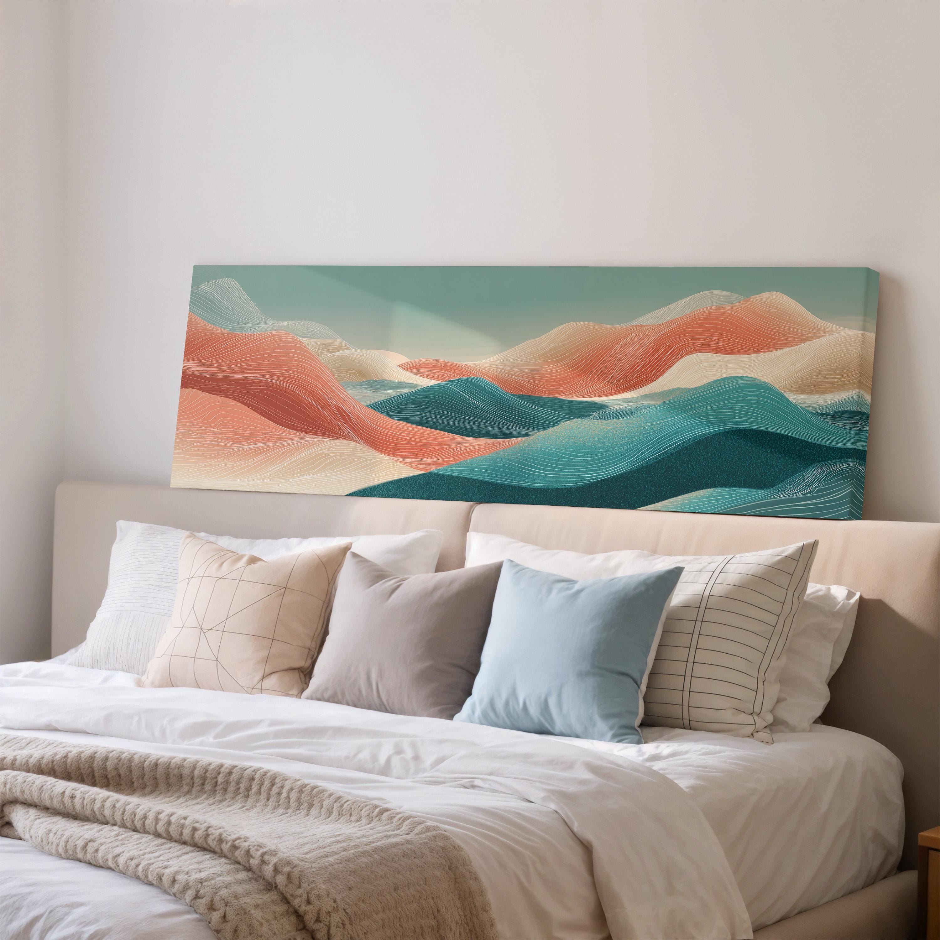 a large, colorful landscape painting hanging on a wall above a bed with white bedding and pillows.