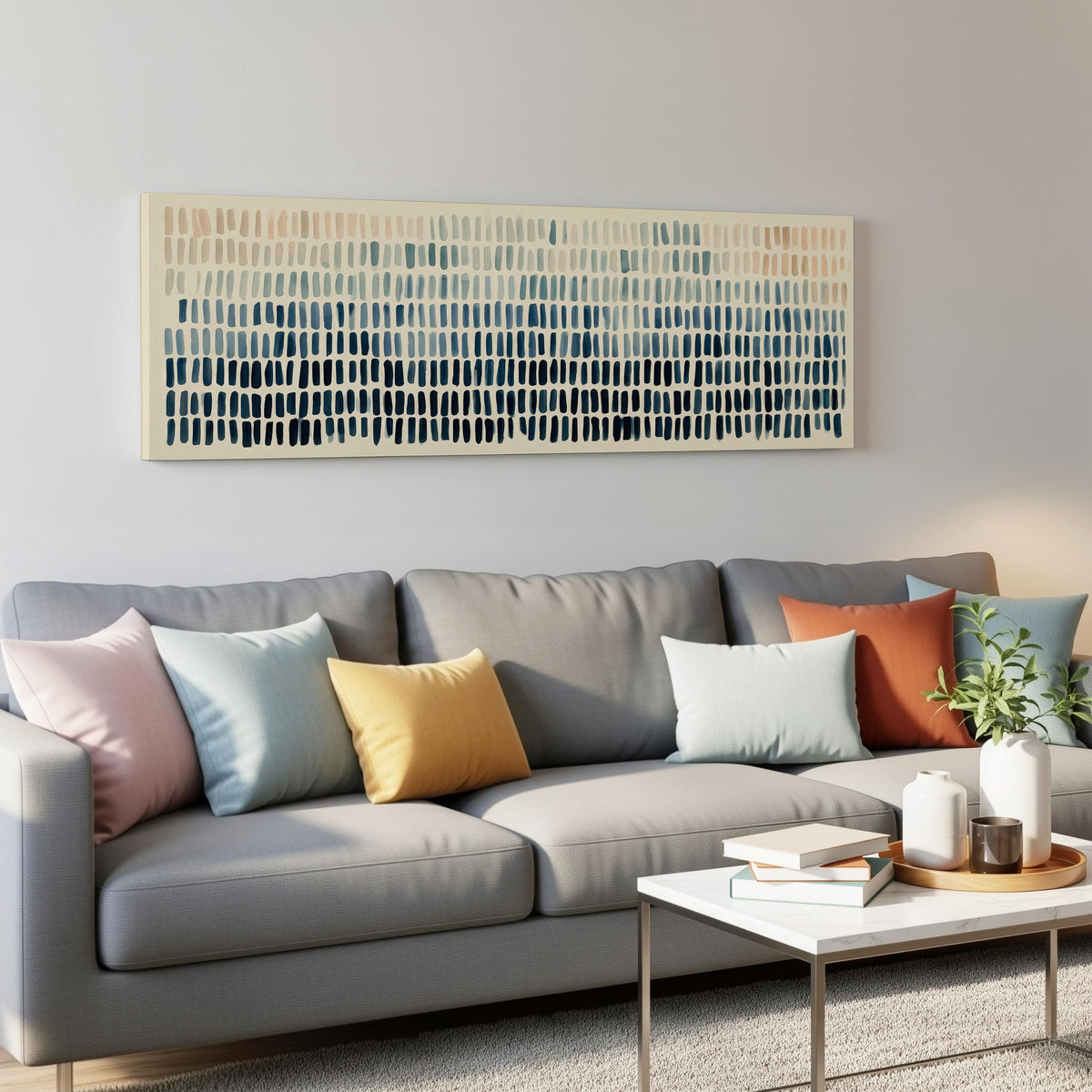 Brushmarks fading from peach to navy panoramic canvas print above a grey sofa in a living room