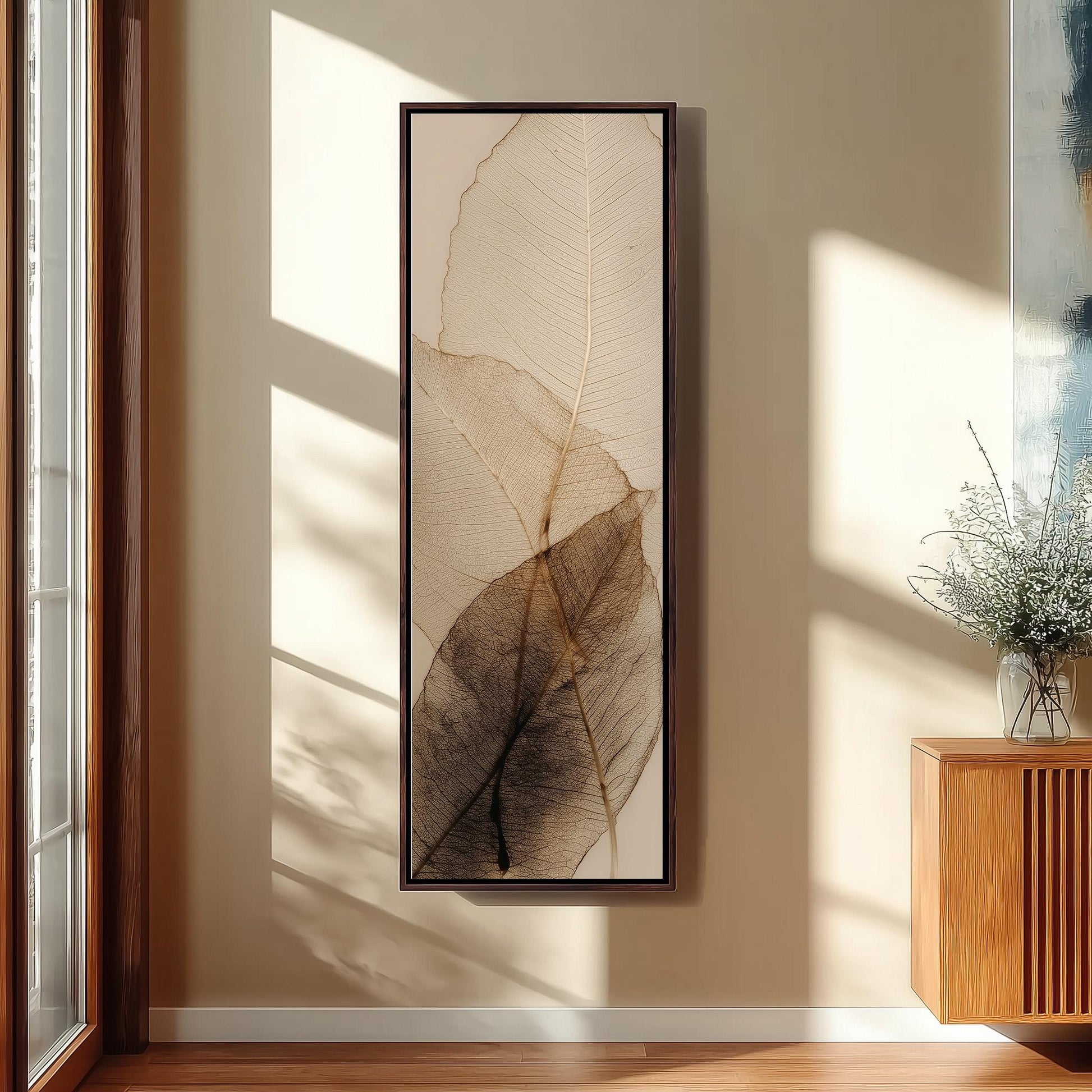 a large framed artwork hanging on a wall, depicting a close-up of a leaf with intricate details.