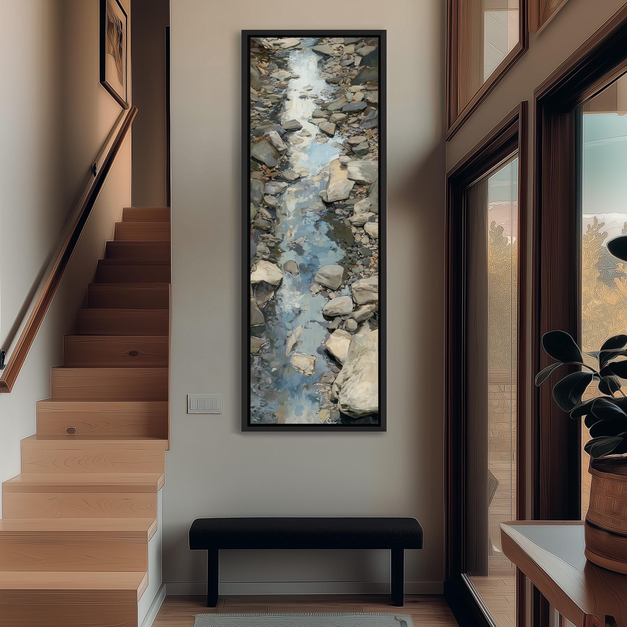 a hallway with a large painting of a rocky stream hanging on the wall. The painting is framed and appears to be the focal point of the space. The hallway has a wooden staircase leading up to the painting, and there is a bench in the foreground. The overall atmosphere of the image is calm and serene, with the natural elements of the painting contrasting with the more man-made elements of the staircase and bench.