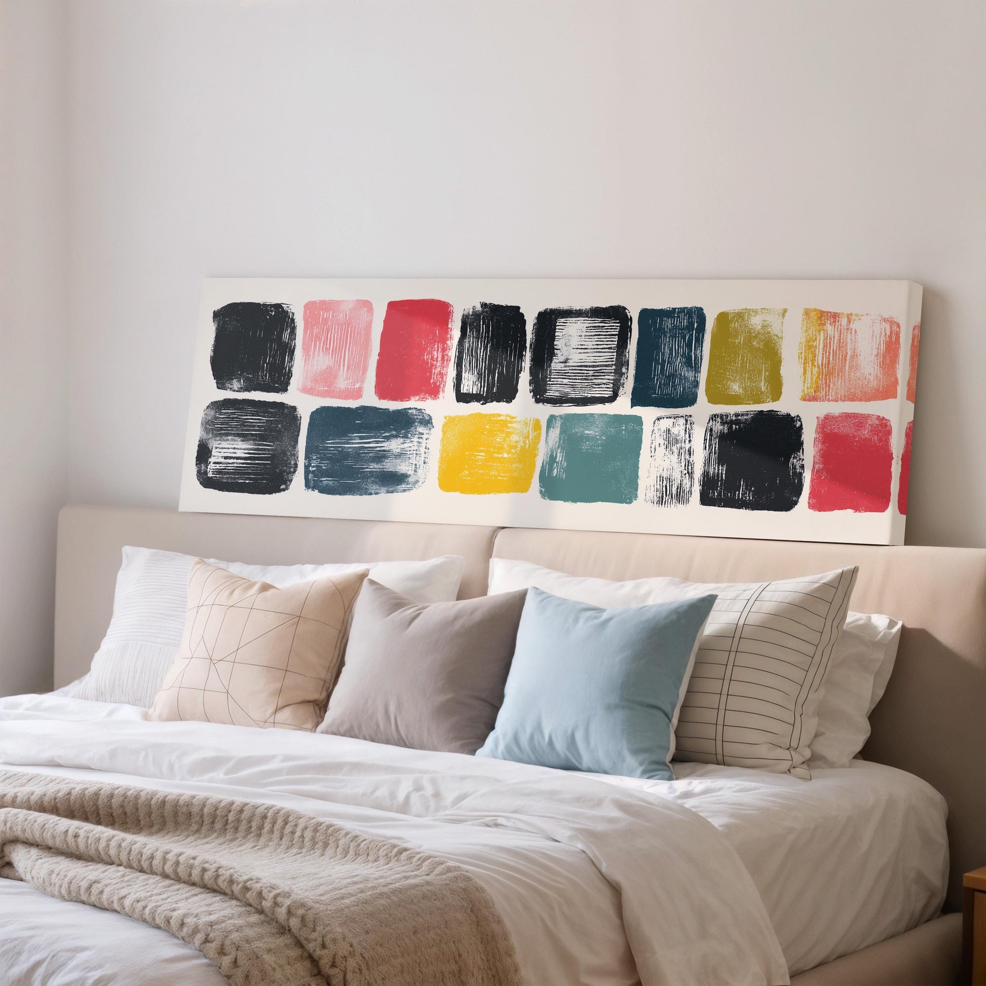 a well-made bed with a variety of colorful pillows and a large abstract painting on the wall above it.