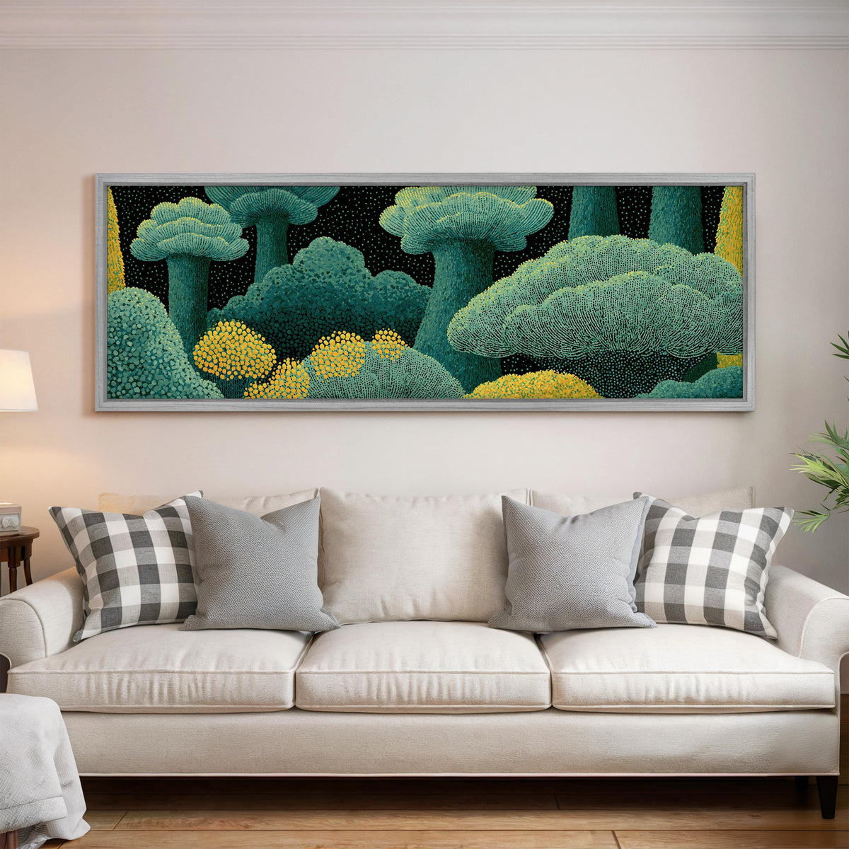 Teal dotted treetops panoramic canvas print above a white sofa in a bright living room