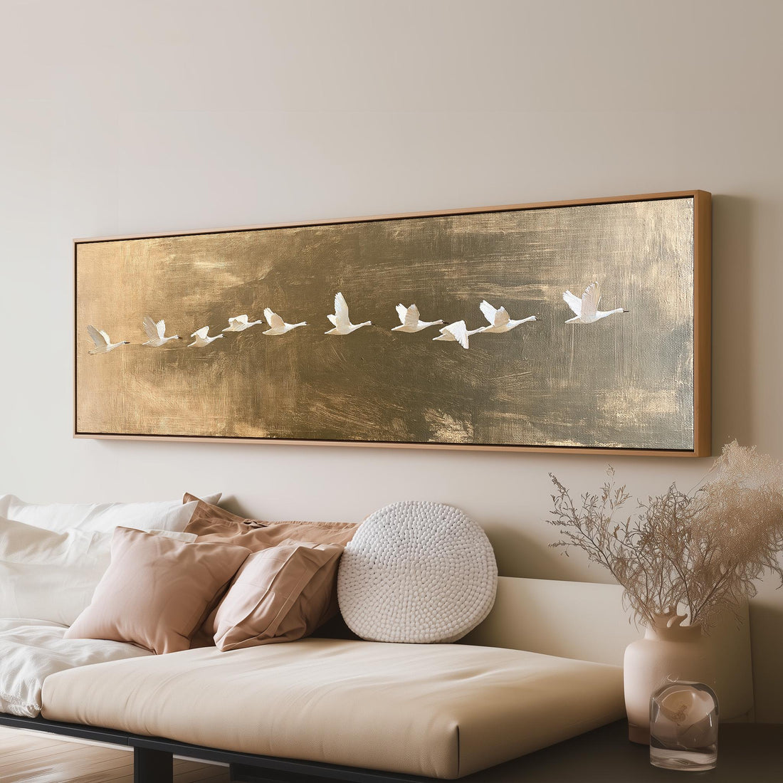 Flying geese over a gold background long horizontal canvas print above a sofa in a living room