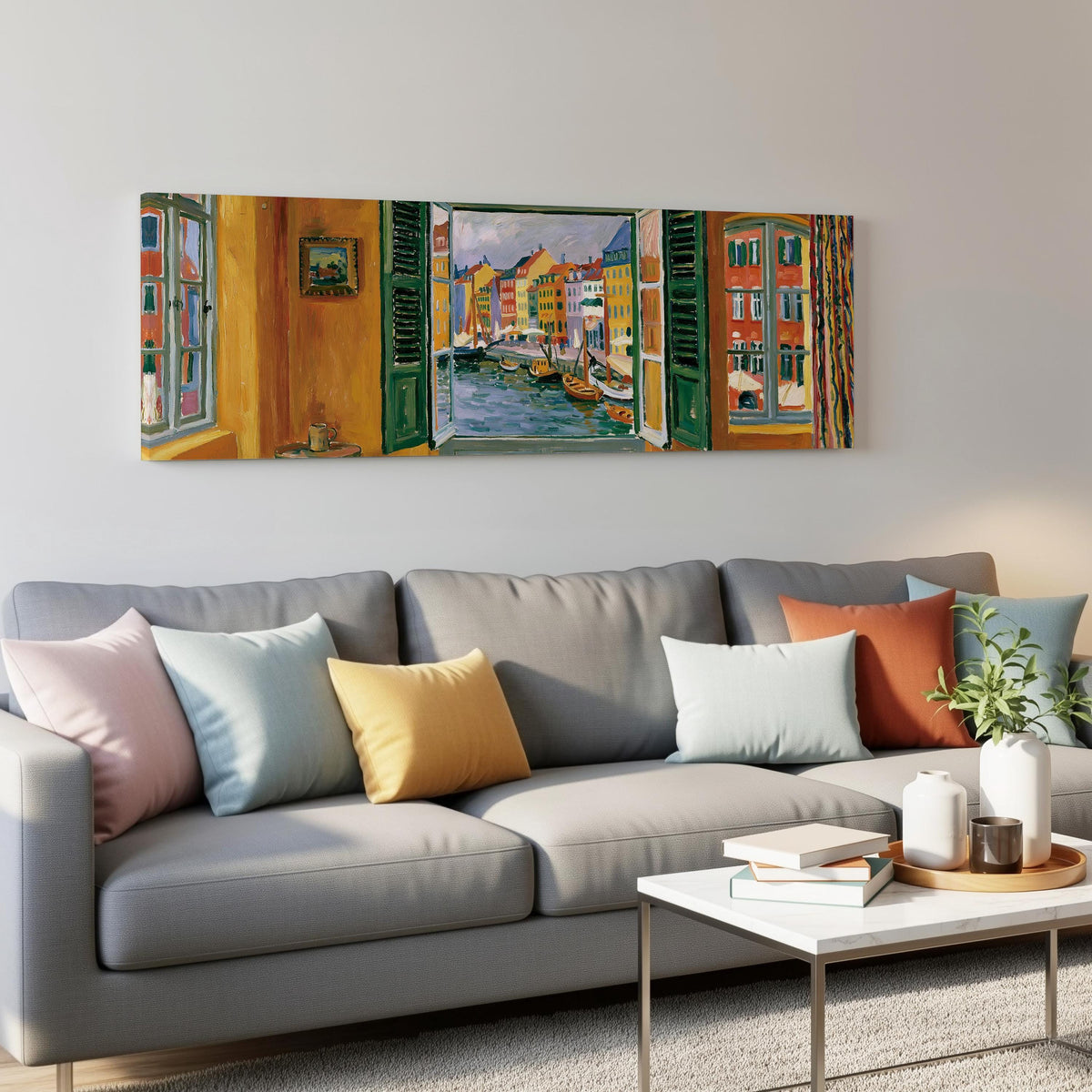 Copenhagen's colorful canal through a window panoramic canvas print above a grey sofa in a living room