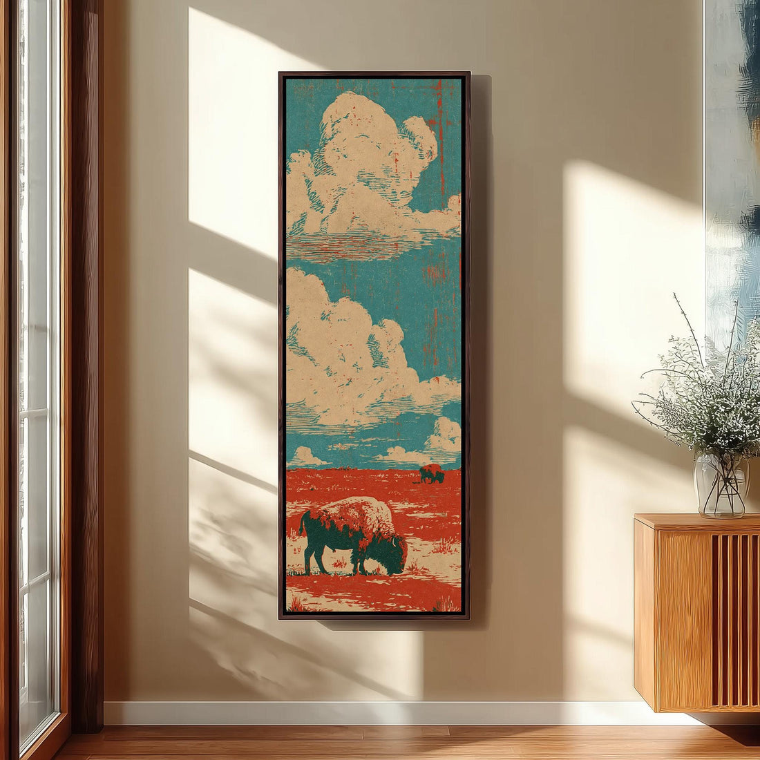 Bison on a red prairie under clouds long vertical canvas print in a sunlit living space