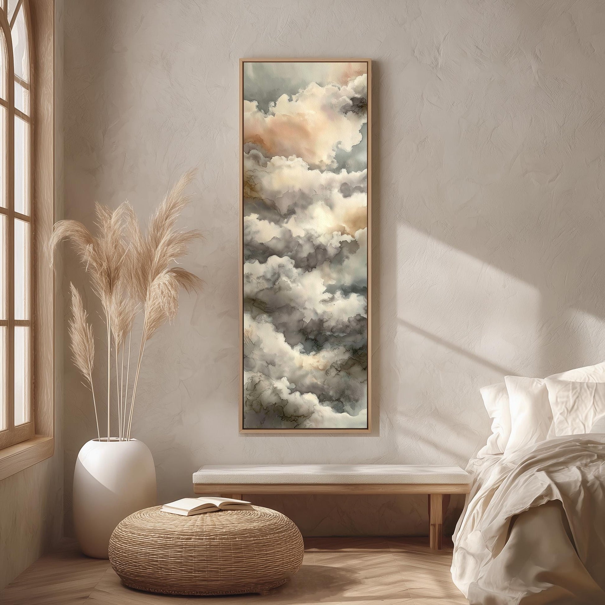 a serene bedroom scene with a large painting of clouds hanging on the wall, a white bed with a white pillow, a white vase with tall potted plants, and a woven ottoman.