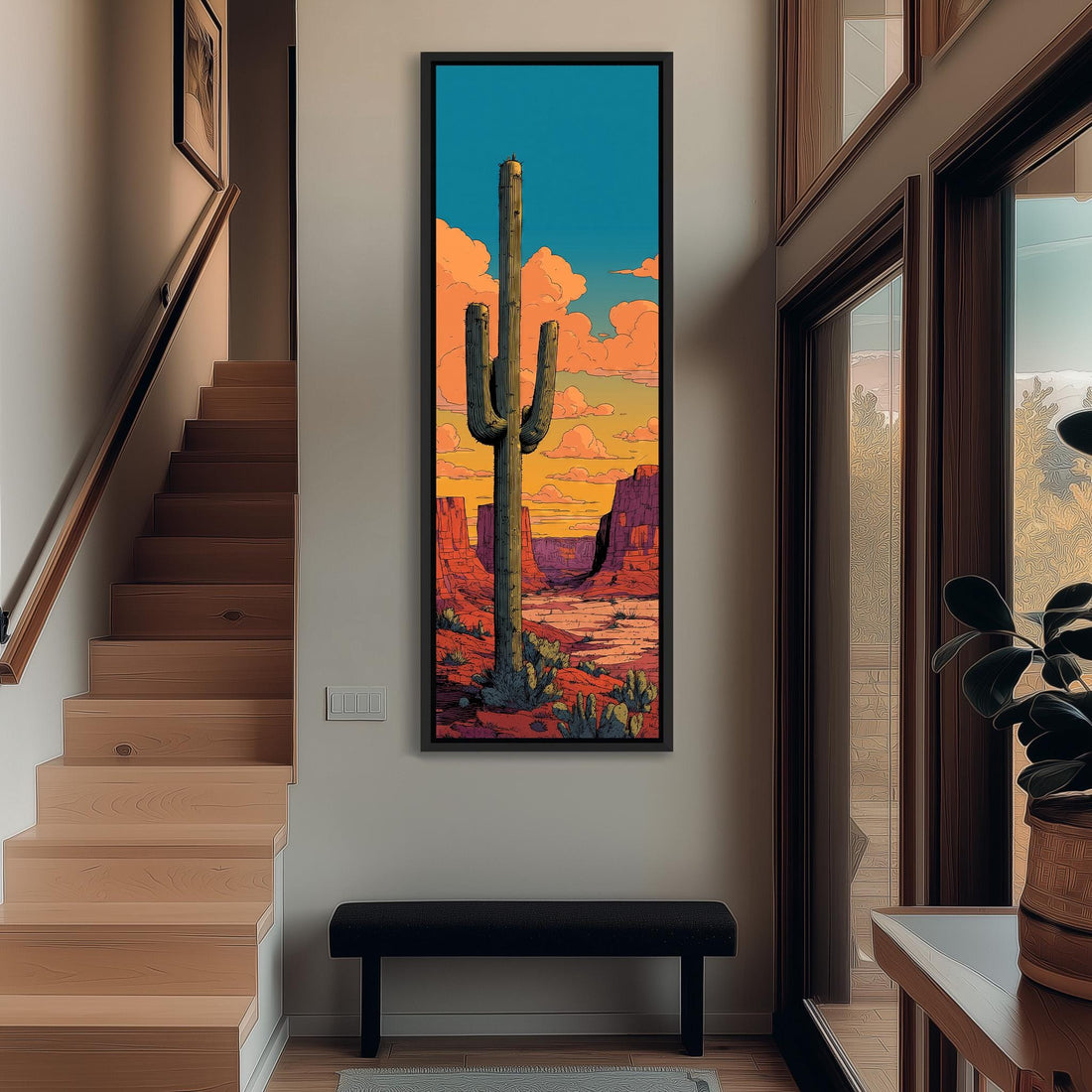 a large framed painting of a cactus in a desert landscape, with a colorful sky in the background.