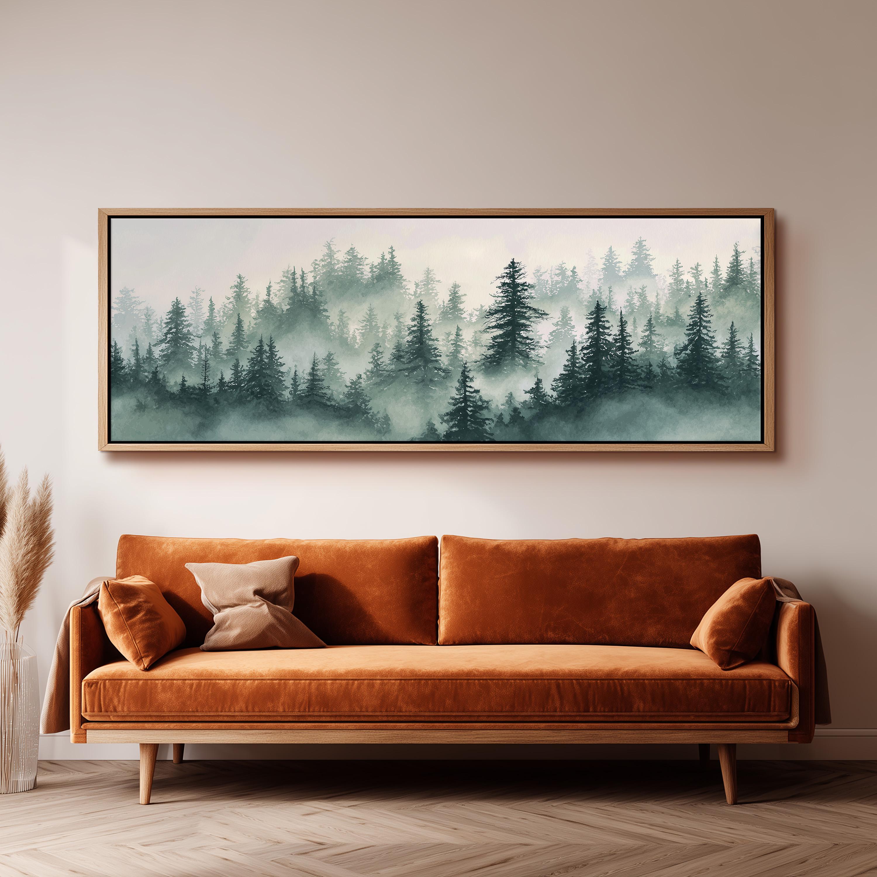 a large, framed painting of a forest scene hanging on a wall above a brown sofa.