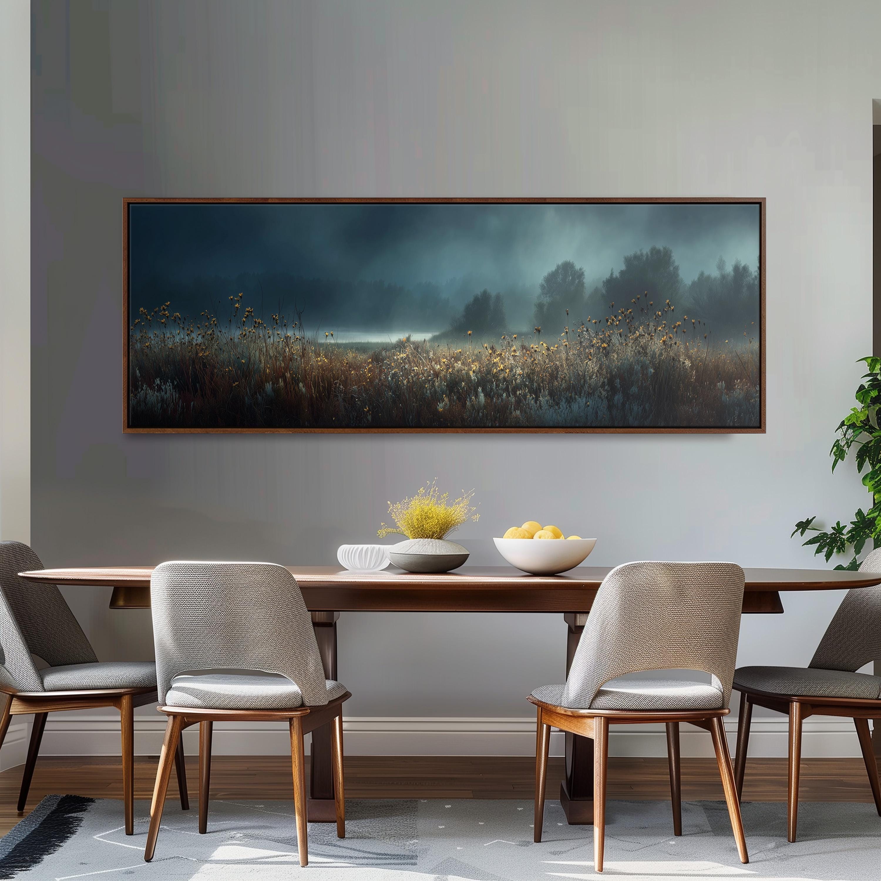 a dining room with a large painting of a field hanging on the wall above a wooden dining table with four chairs. The table is set with a bowl of fruit and a vase of flowers, creating a cozy and inviting atmosphere.