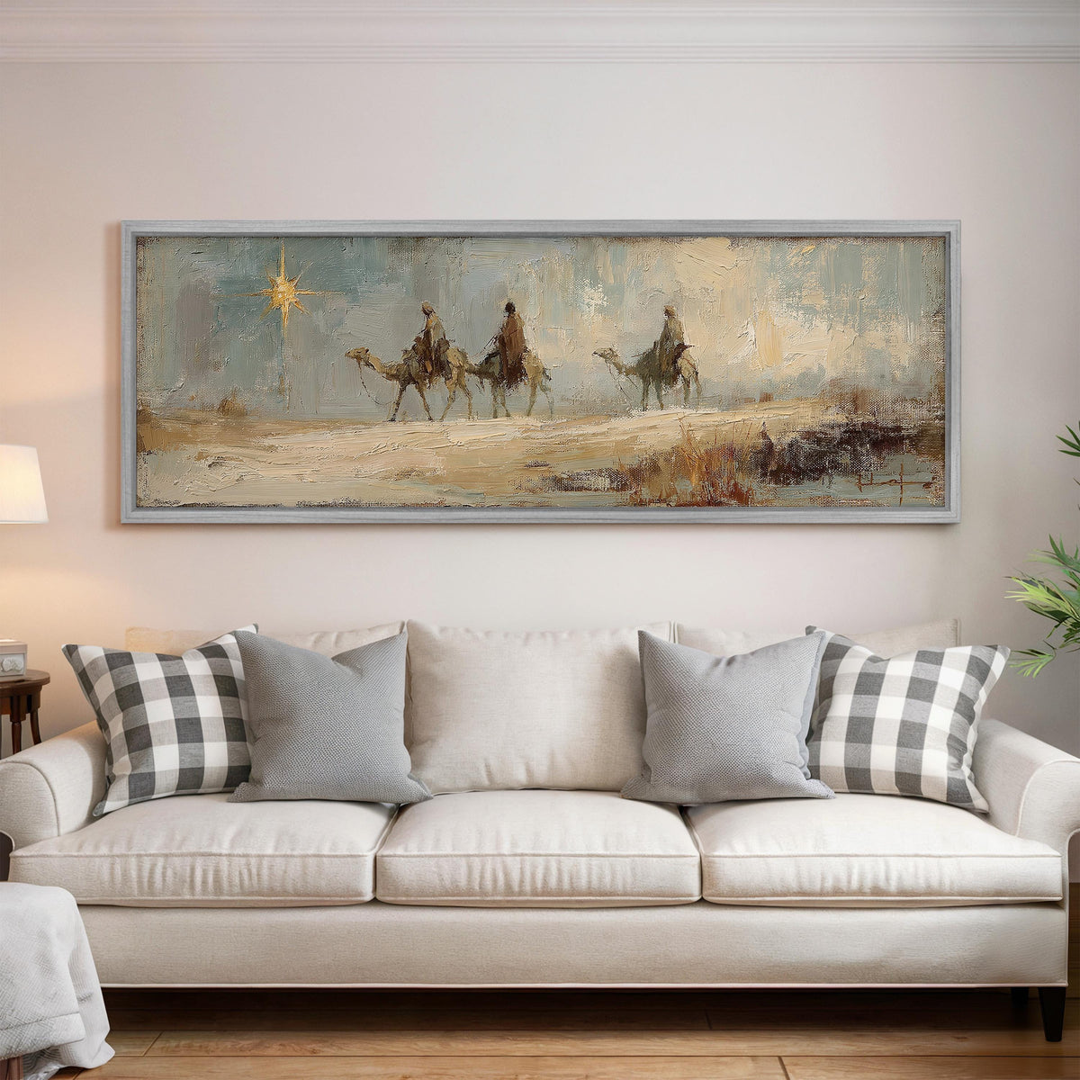 Wise men on camels following the star panoramic canvas print above a white sofa in a bright living room