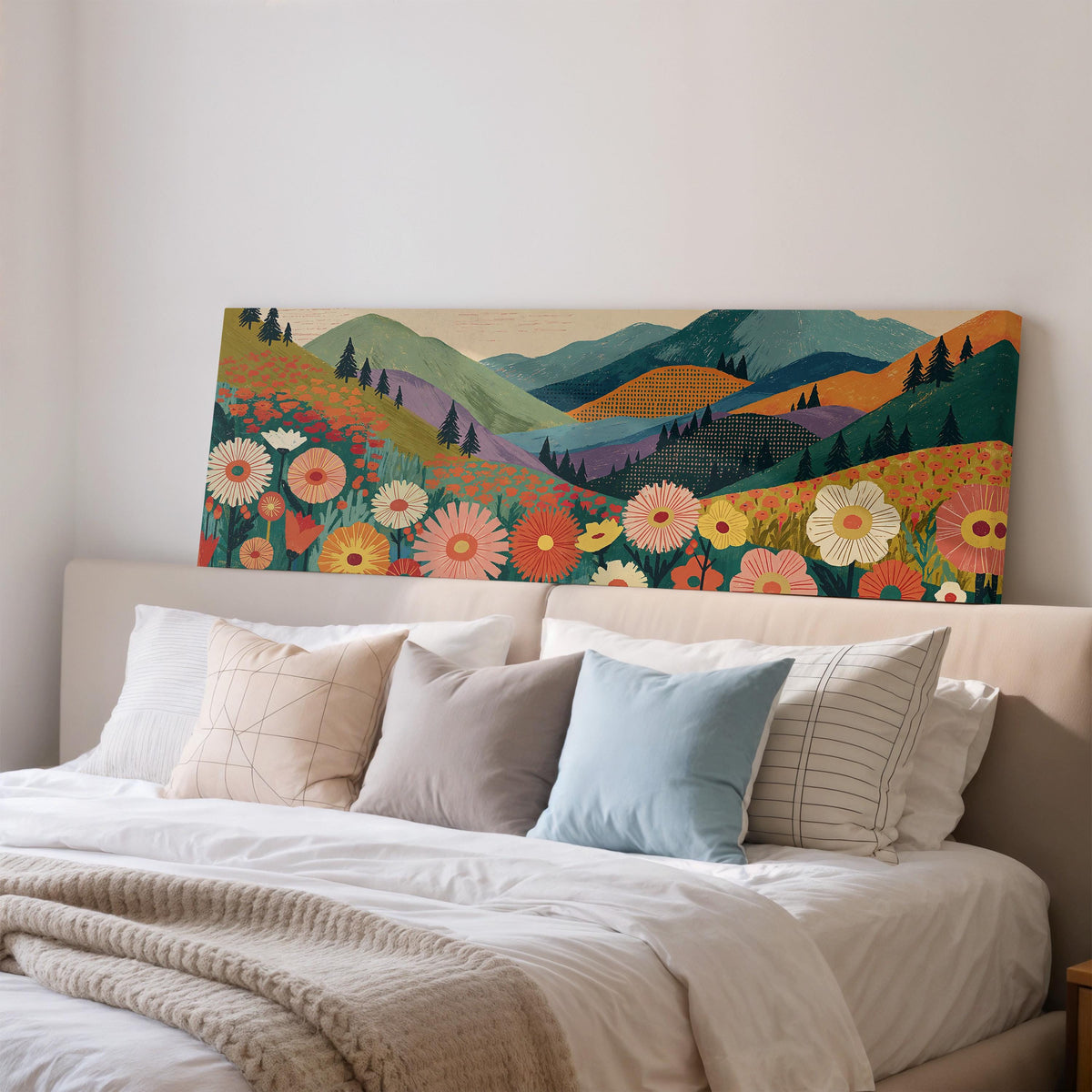 Wildflower valley below patterned mountains wide panoramic canvas print above a bed in a bedroom
