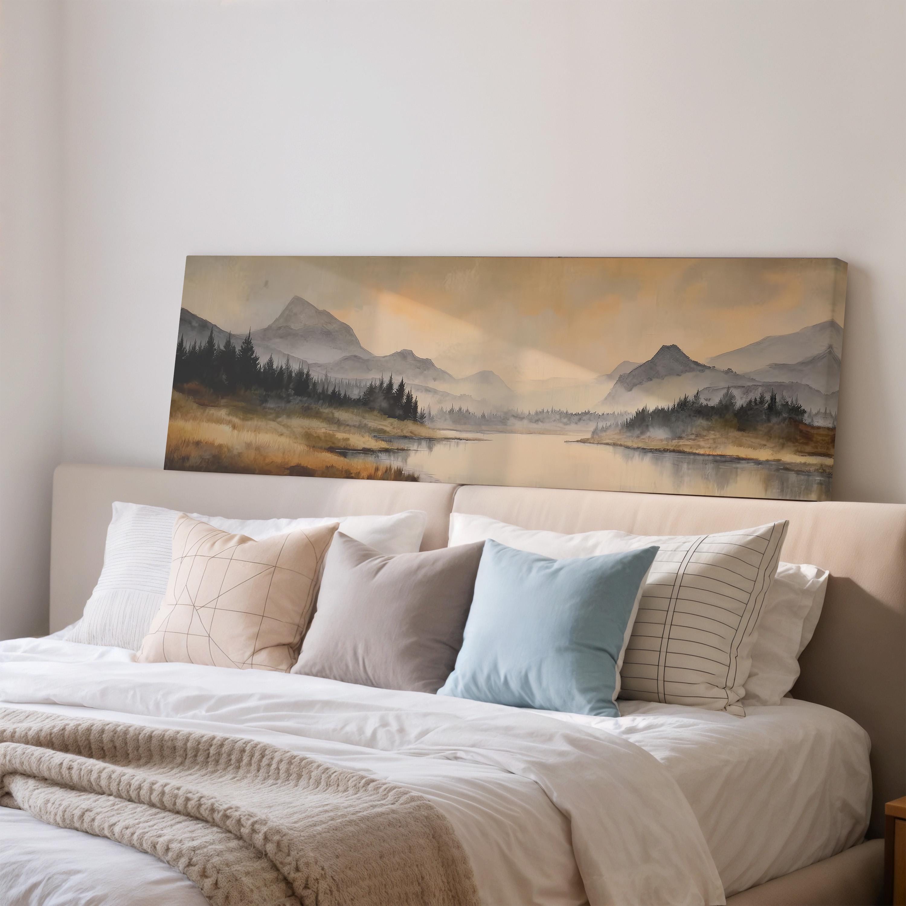 a large landscape painting hanging on a wall above a bed with white bedding and pillows.