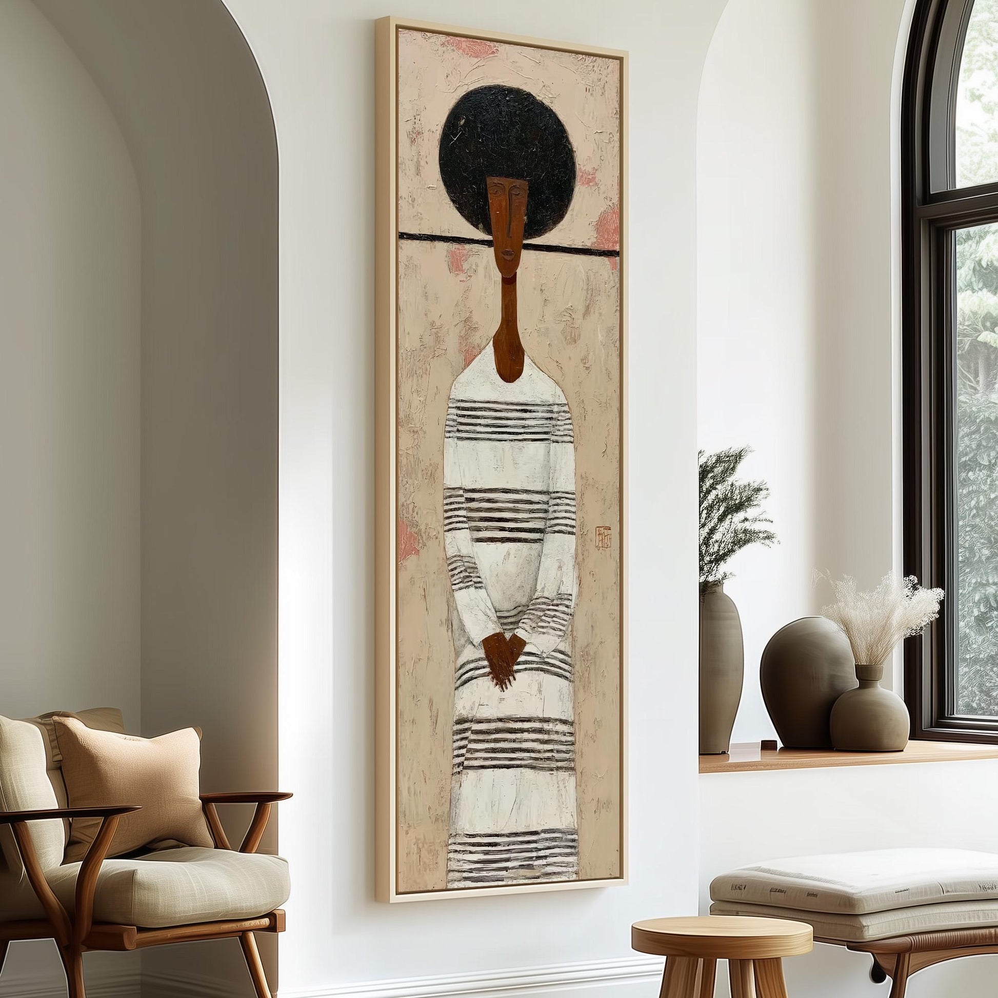 a large painting of a woman with a black afro hairstyle, wearing a striped dress, hanging on a white wall in a room with a wooden chair and a small table.