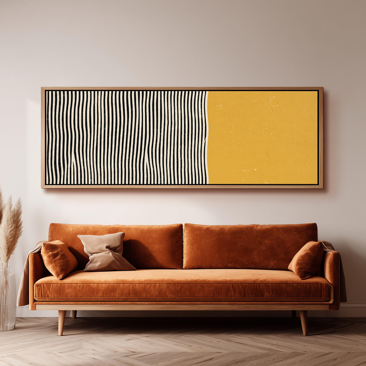 Black wavy stripes beside a mustard block panoramic canvas print above a sofa in a living room