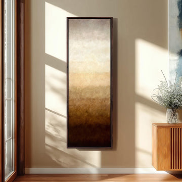 a large, rectangular painting hanging on a wall in a room with a wooden cabinet and a vase of flowers.