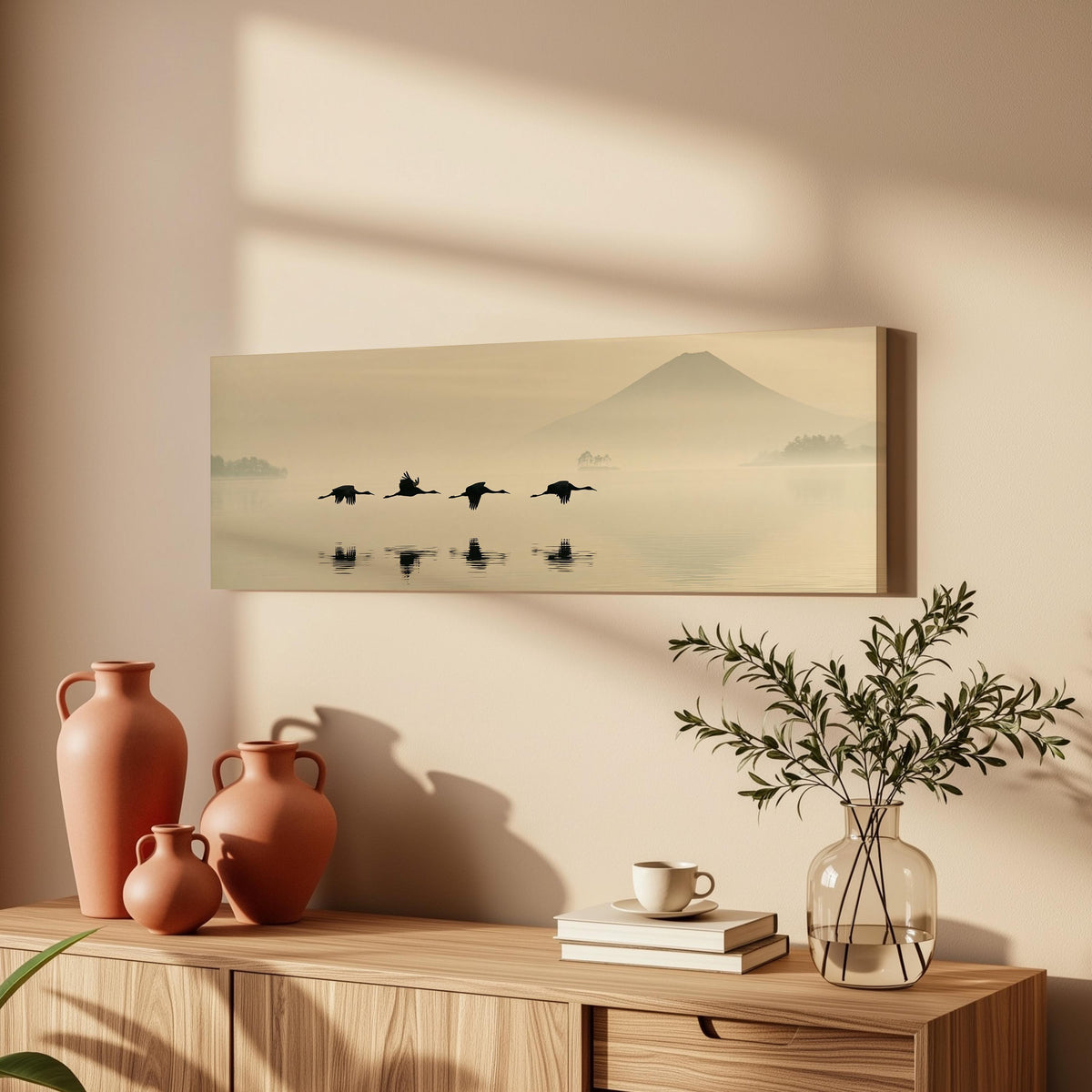 Birds flying low over a lake below Mount Fuji long horizontal canvas print above a wooden sideboard