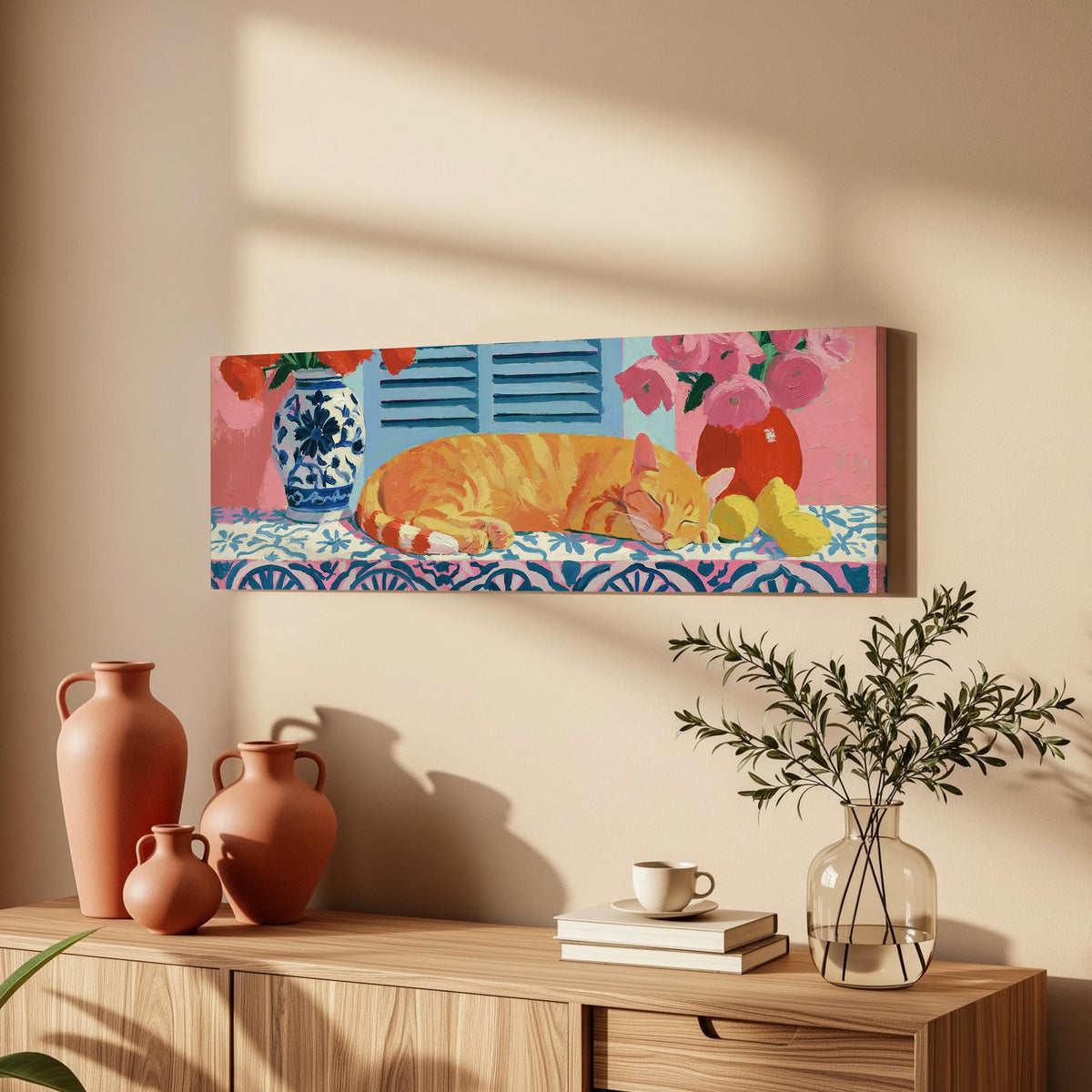 Orange cat napping on a tiled table long horizontal canvas print above a wooden sideboard