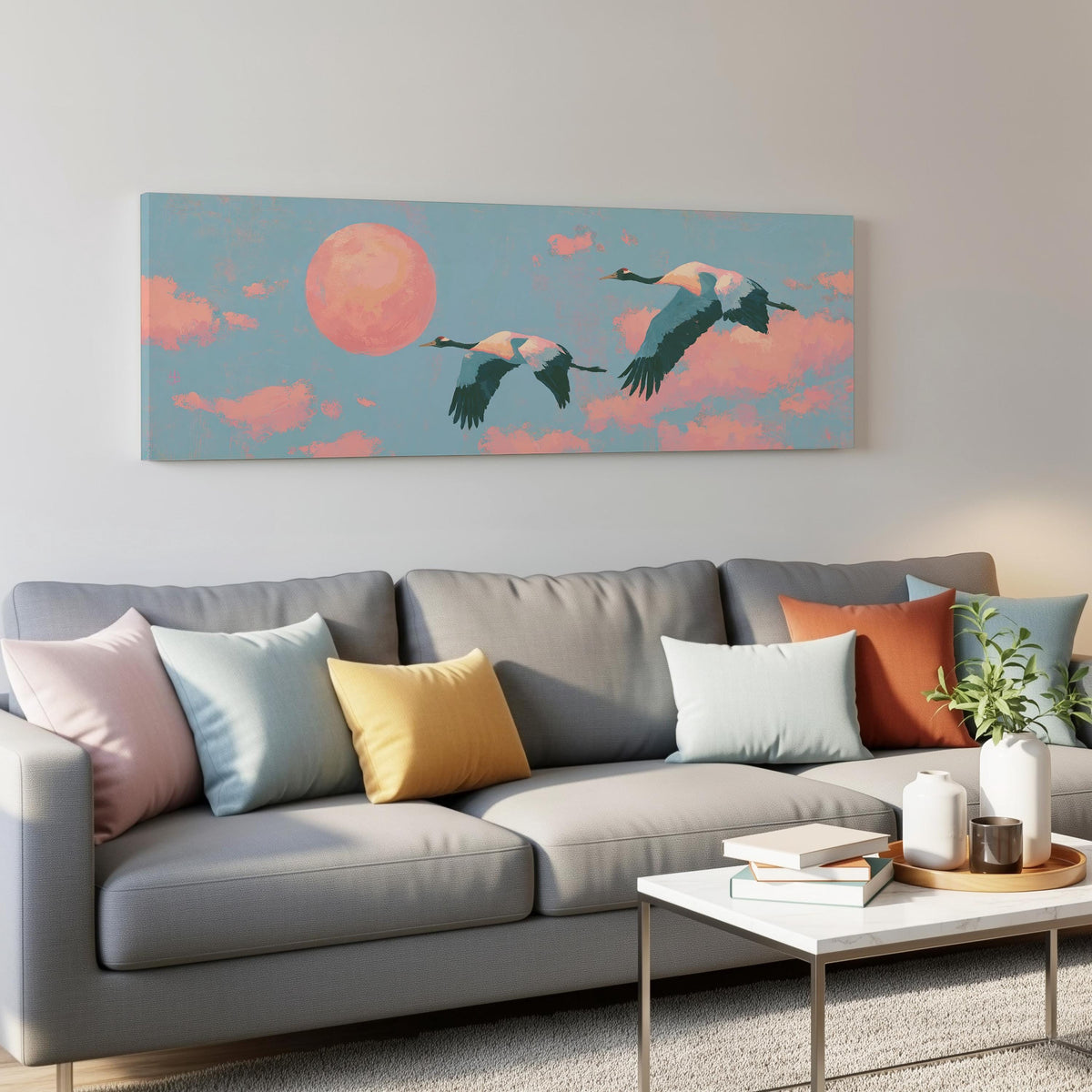 Two cranes flying at sunset panoramic canvas print above a grey sofa in a living room