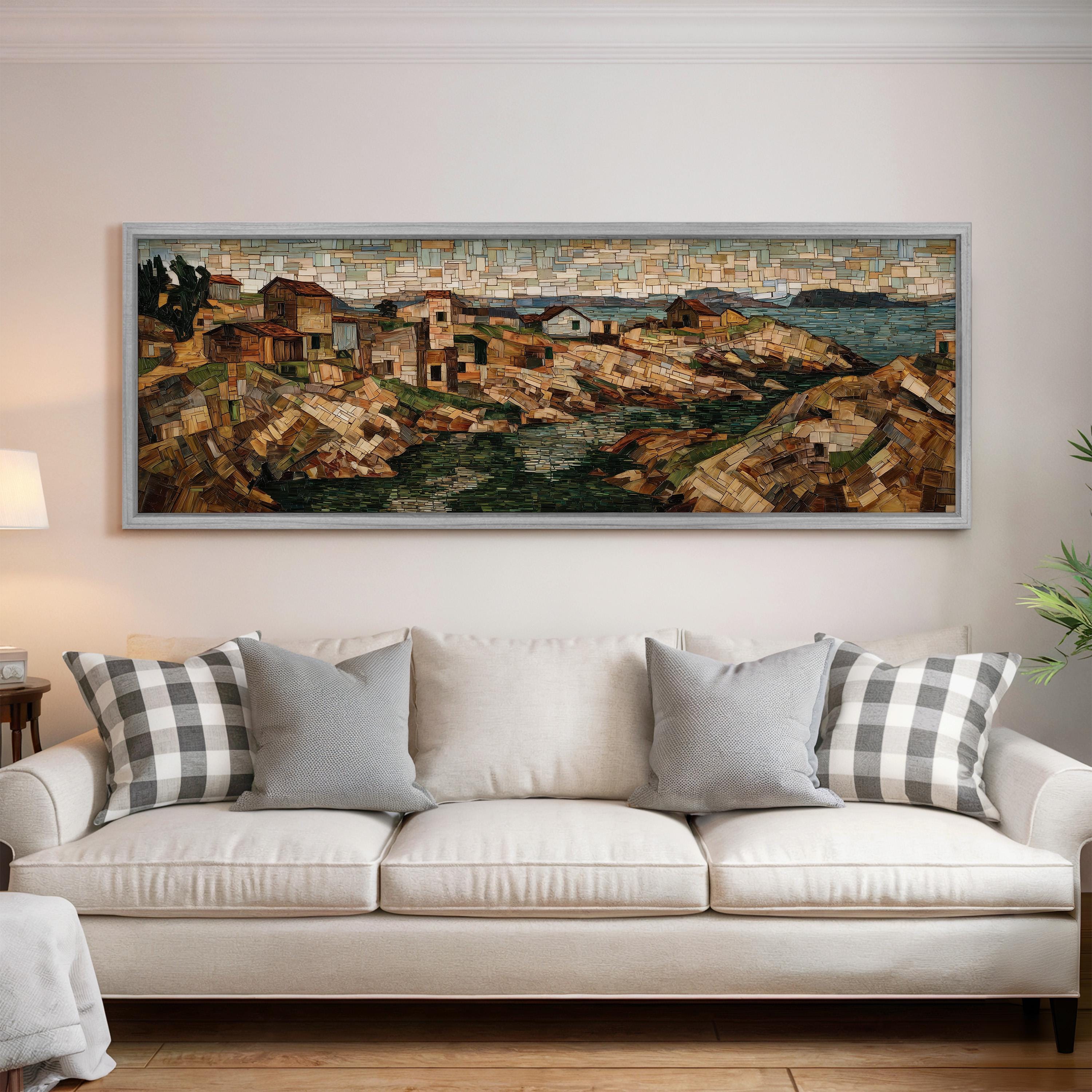 a large, framed painting of a coastal town hanging on a wall above a white couch with gray and white plaid throw pillows.
