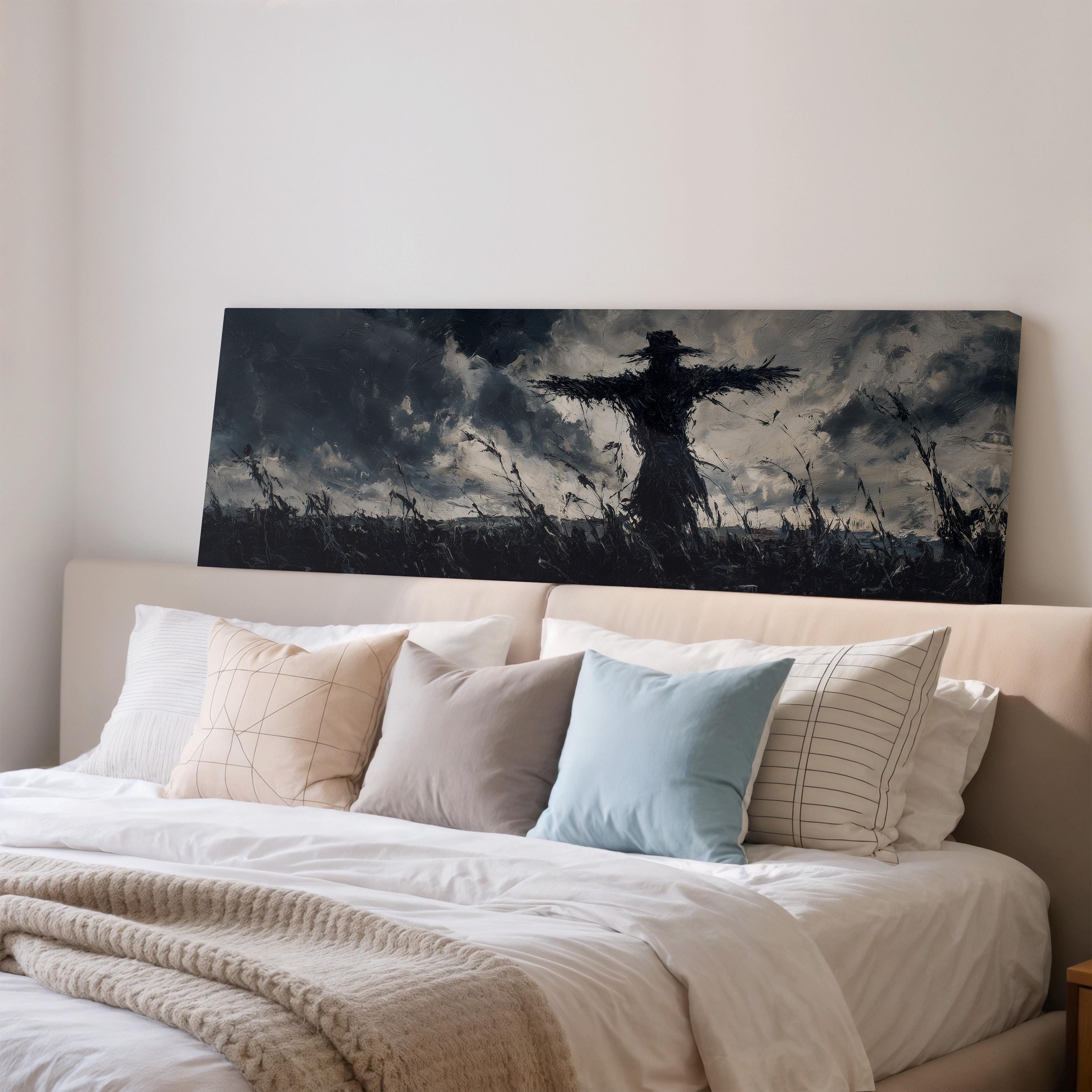a large black and white painting of a scarecrow on a bed with white pillows and a gray blanket.